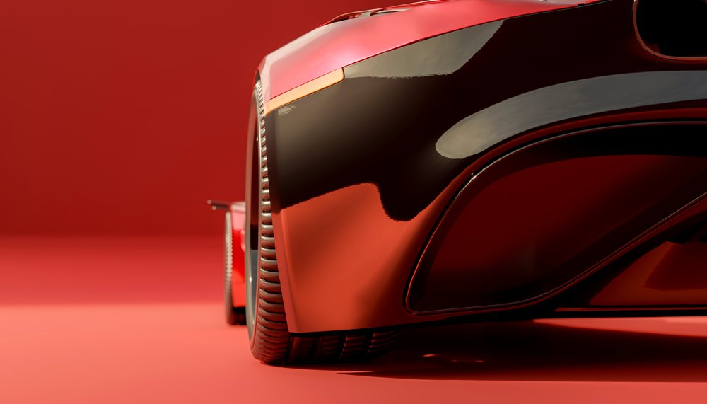 Close-up of a red vehicle's wheel and fender on a matching red