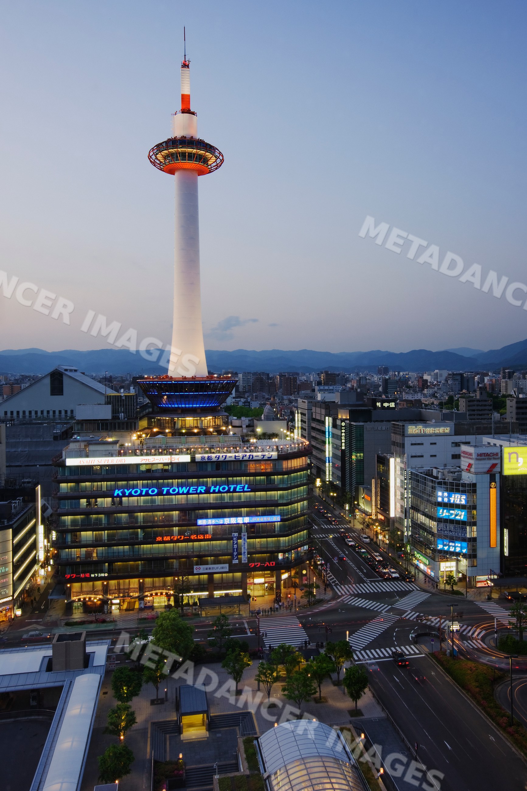Kyoto tower and hotel illuminated at dusk japan cityscape
