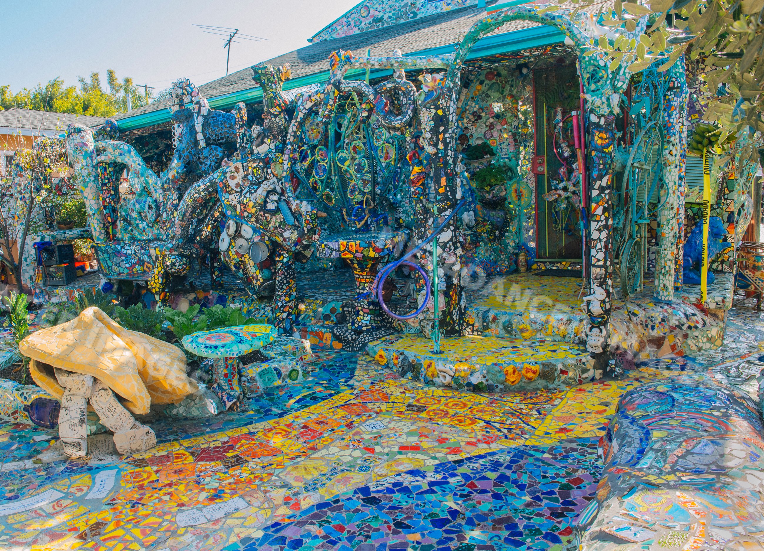 Colorful mosaic art decorating a house facade and yard in california