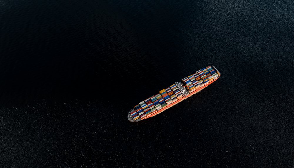 Aerial view of a container ship transporting goods across the ocean