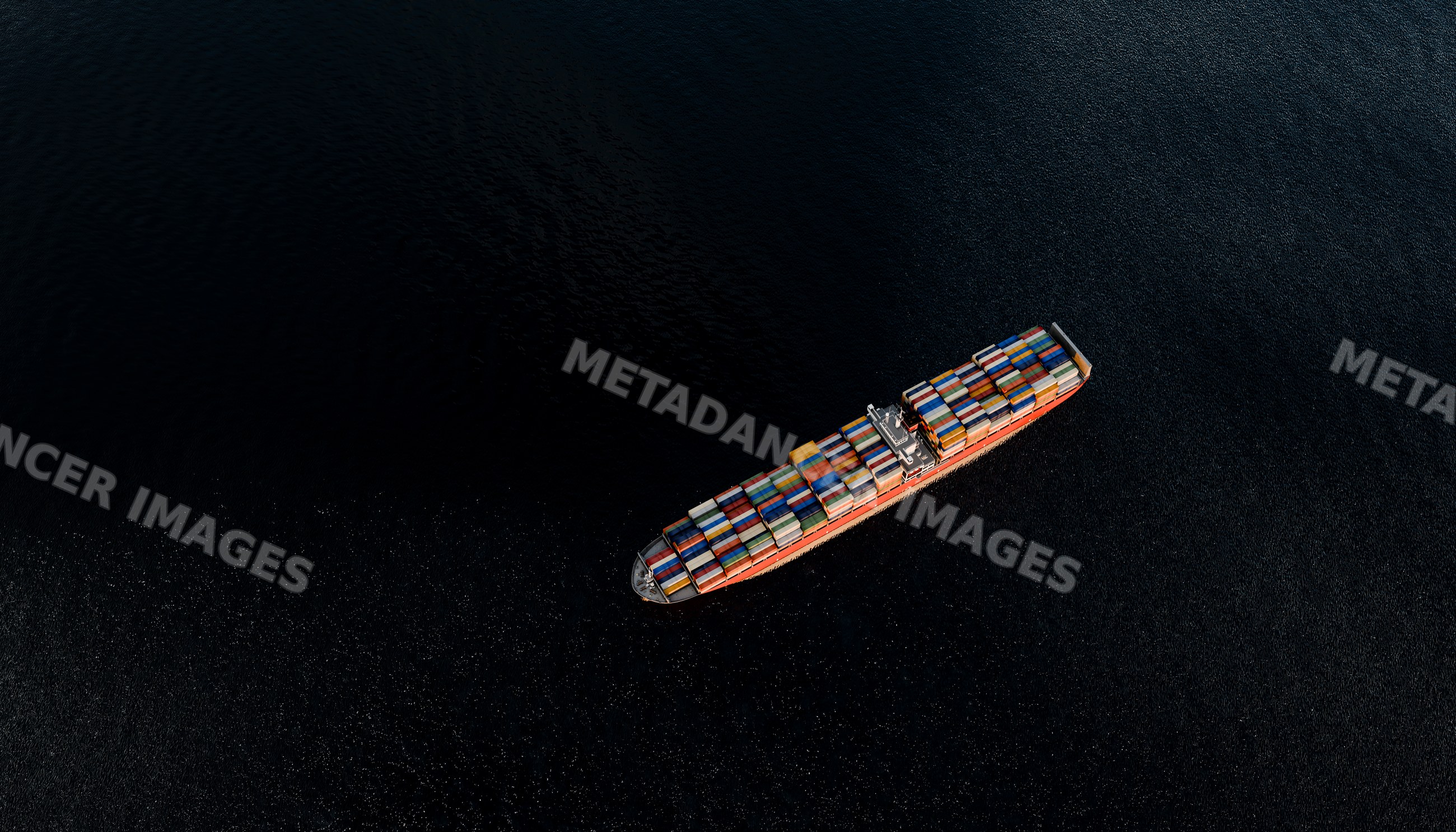 Aerial view of a container ship transporting goods across the ocean