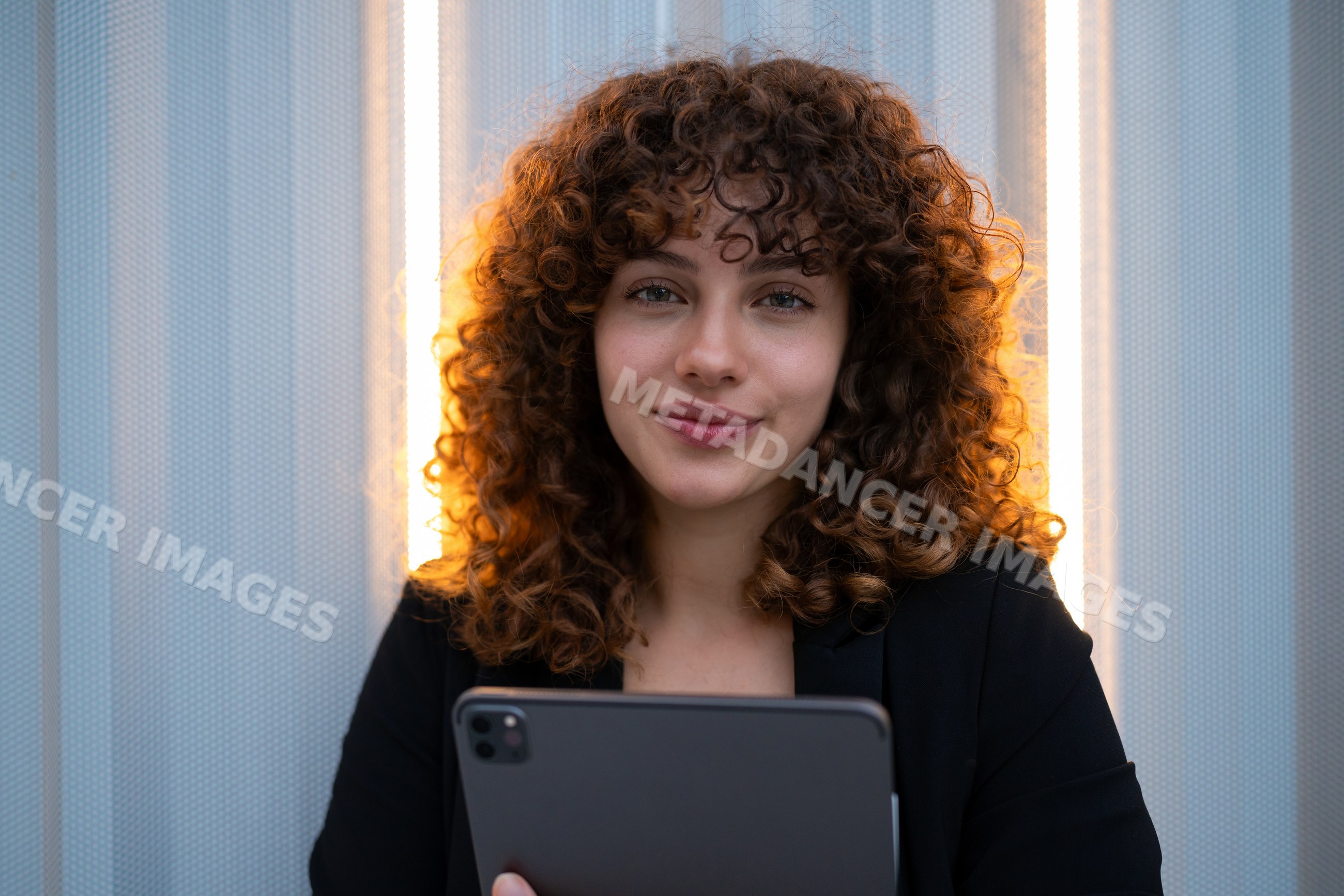 Young white woman holding tablet in indoor business setting