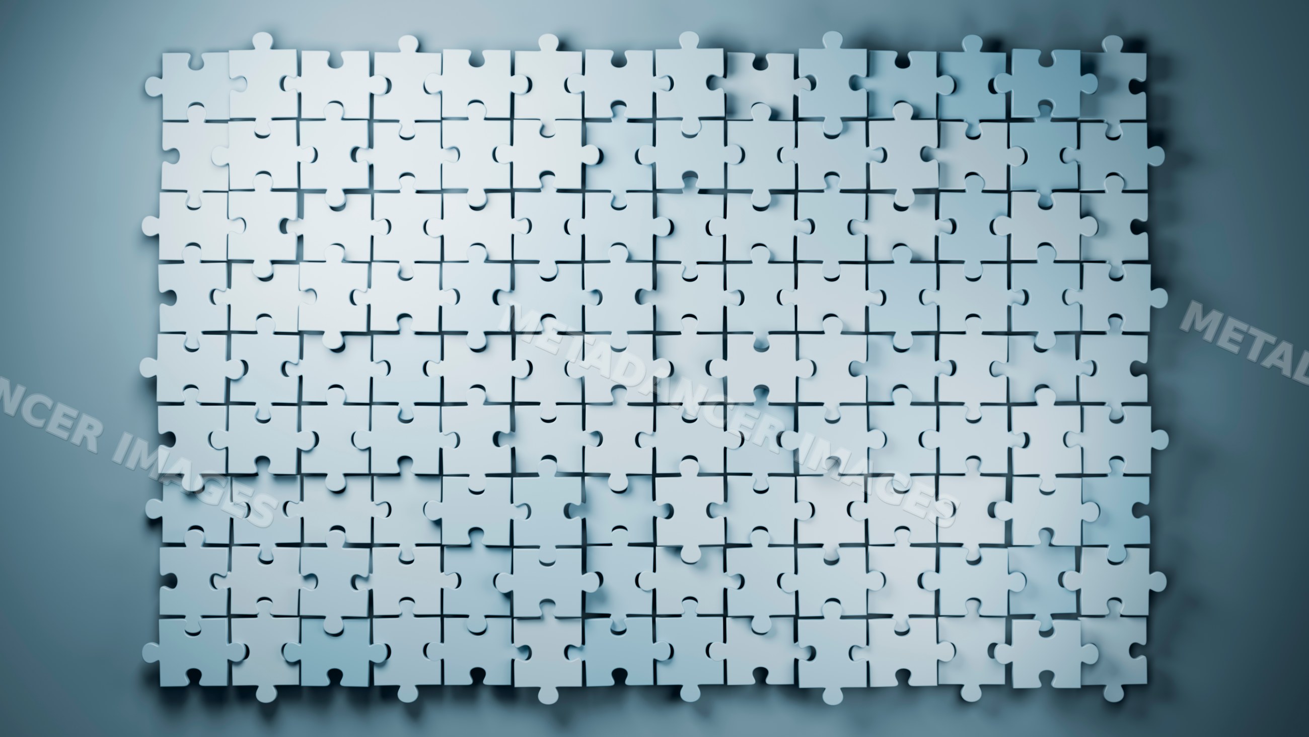 White jigsaw puzzle with many pieces unassembled on flat surface
