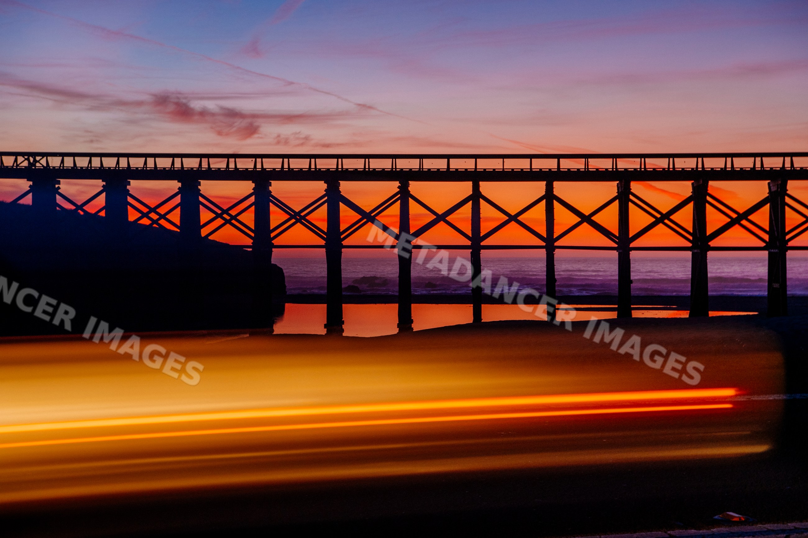 Bridge silhouette with light trails