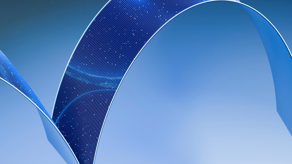 Curved blue solar panels arching against clear sky