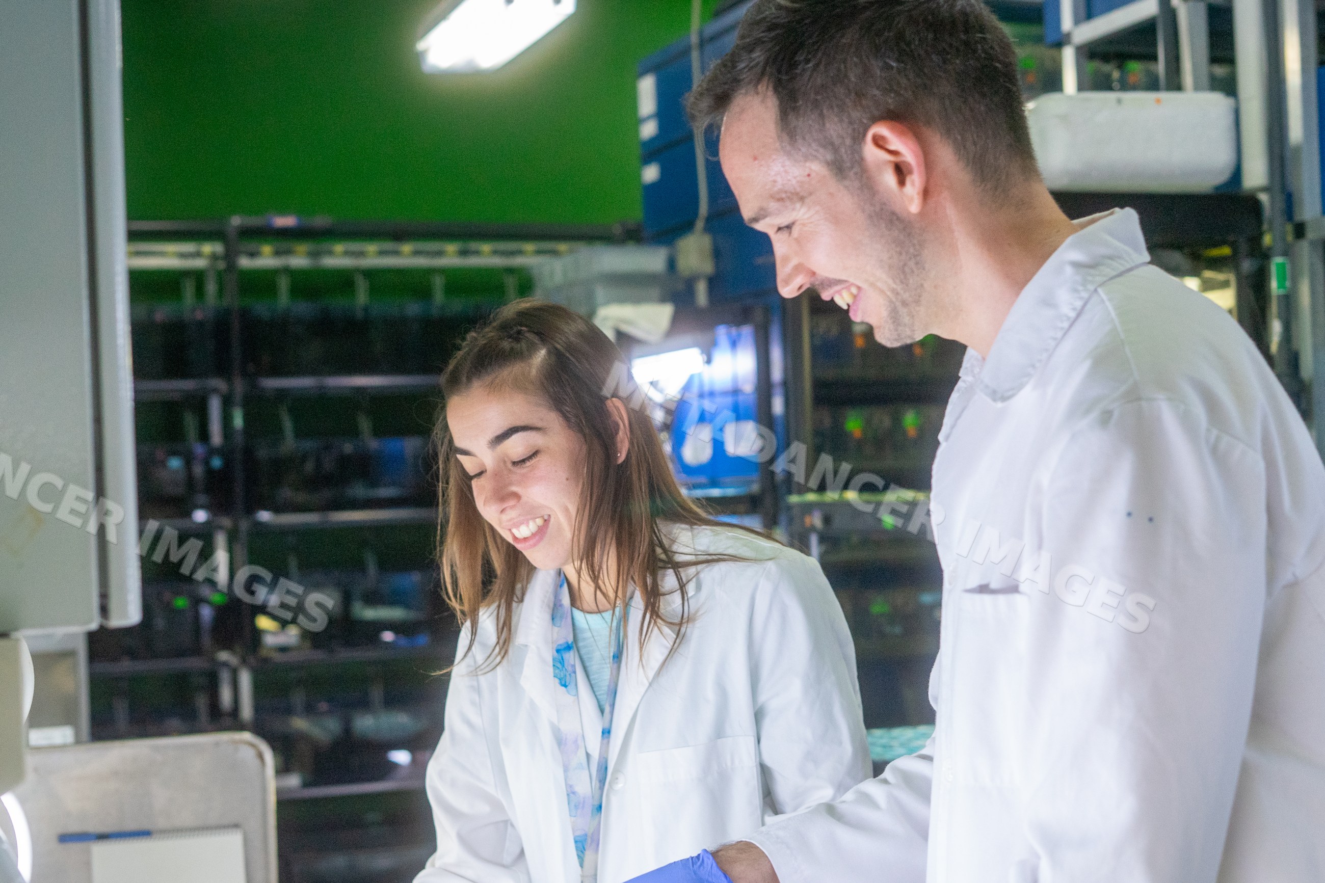 Two scientists collaborate and smile