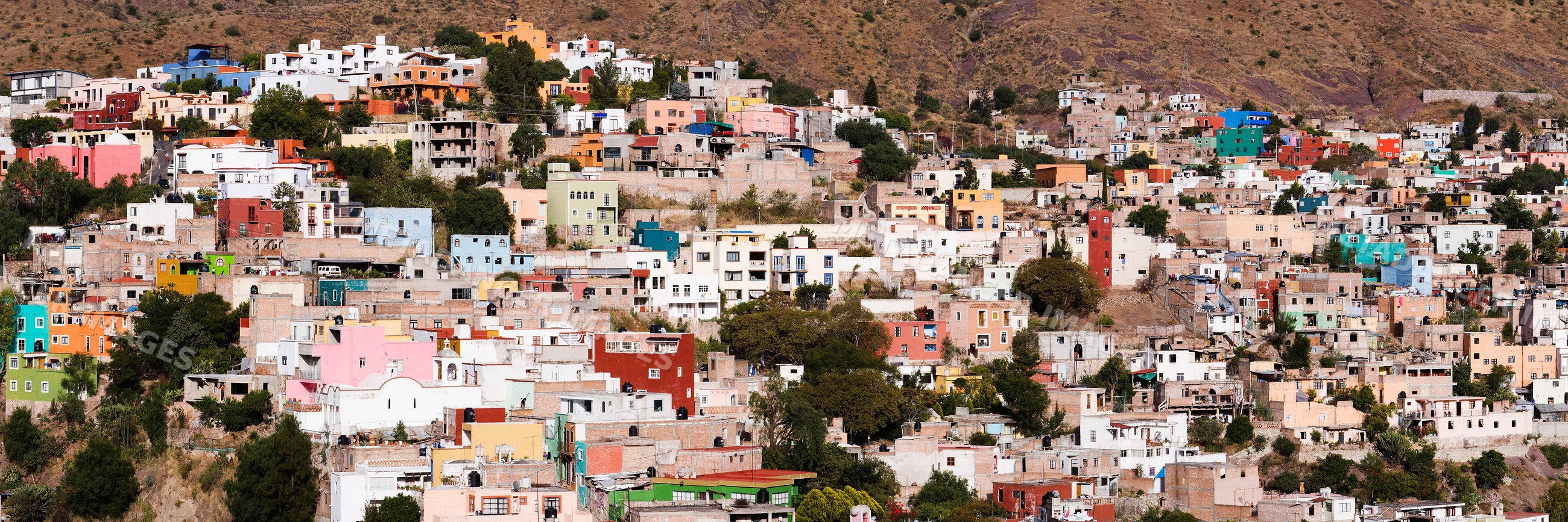 Colorful hillside homes densely built in mexican mountain town