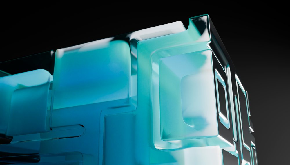 Close-up of a blue translucent glass cube with geometric shapes
