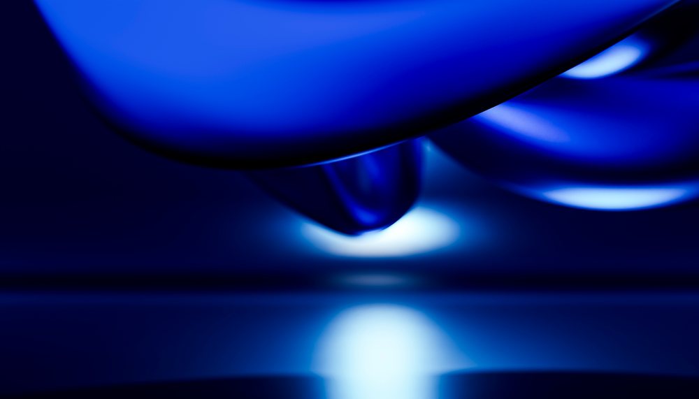 Close-up of glossy blue object with illuminated reflection