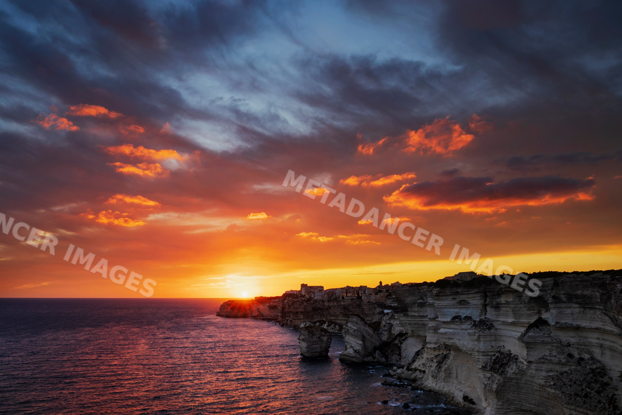 Sunset over cliffs and sea at bonifacio in corsica, france