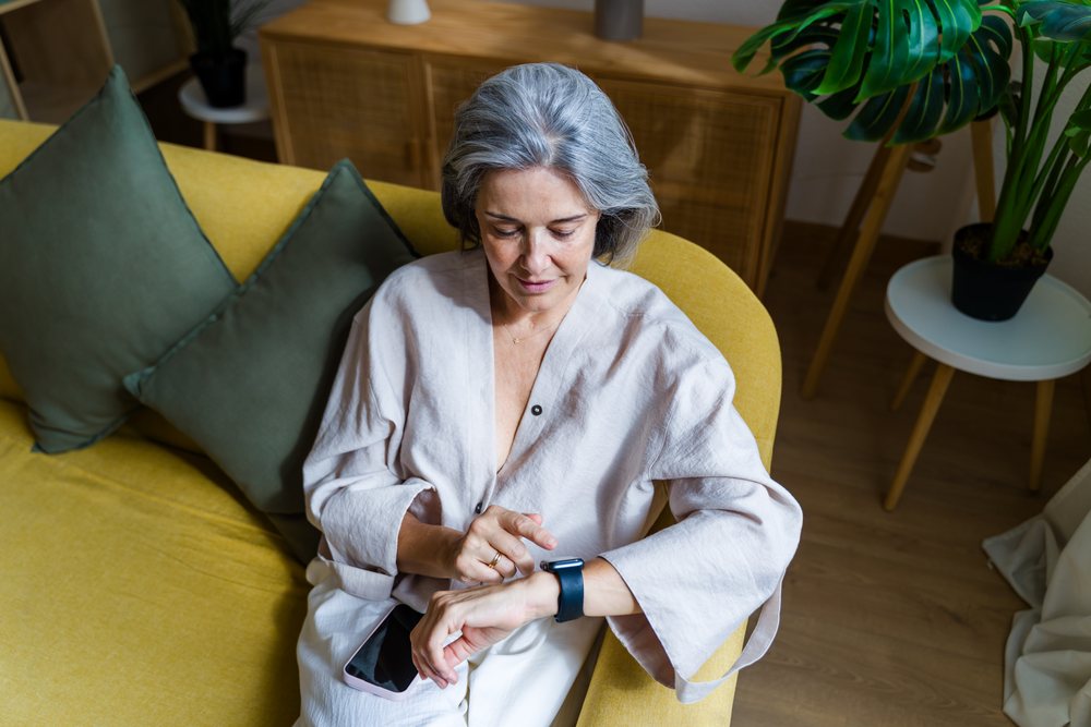 Mature white woman checking smartwatch