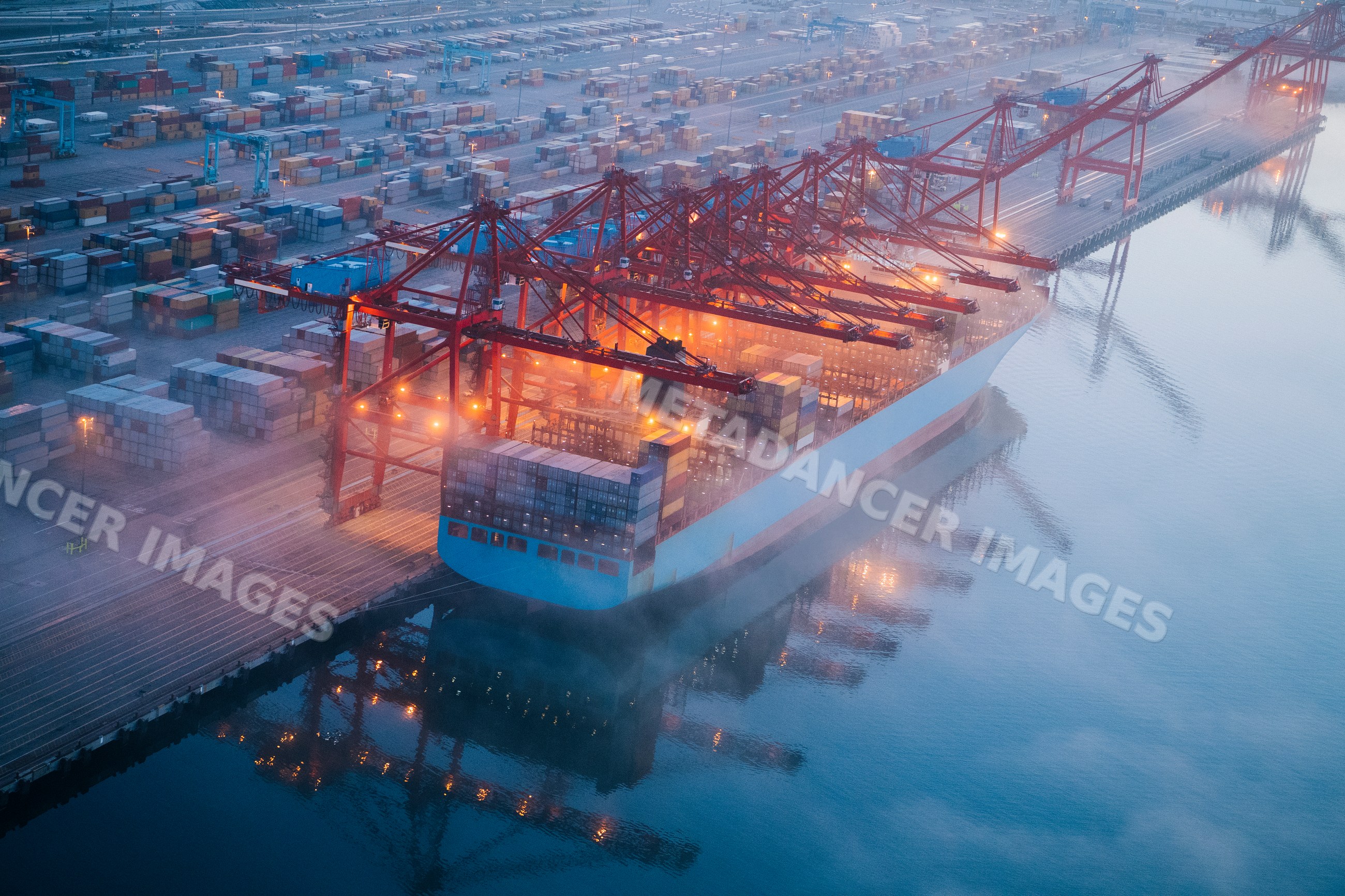 Large container ship unloading cargo at port terminal in Long Beach