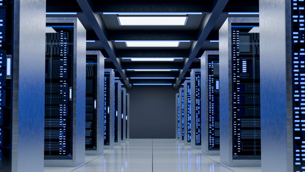 Server racks illuminated by blue lights in modern data center aisle