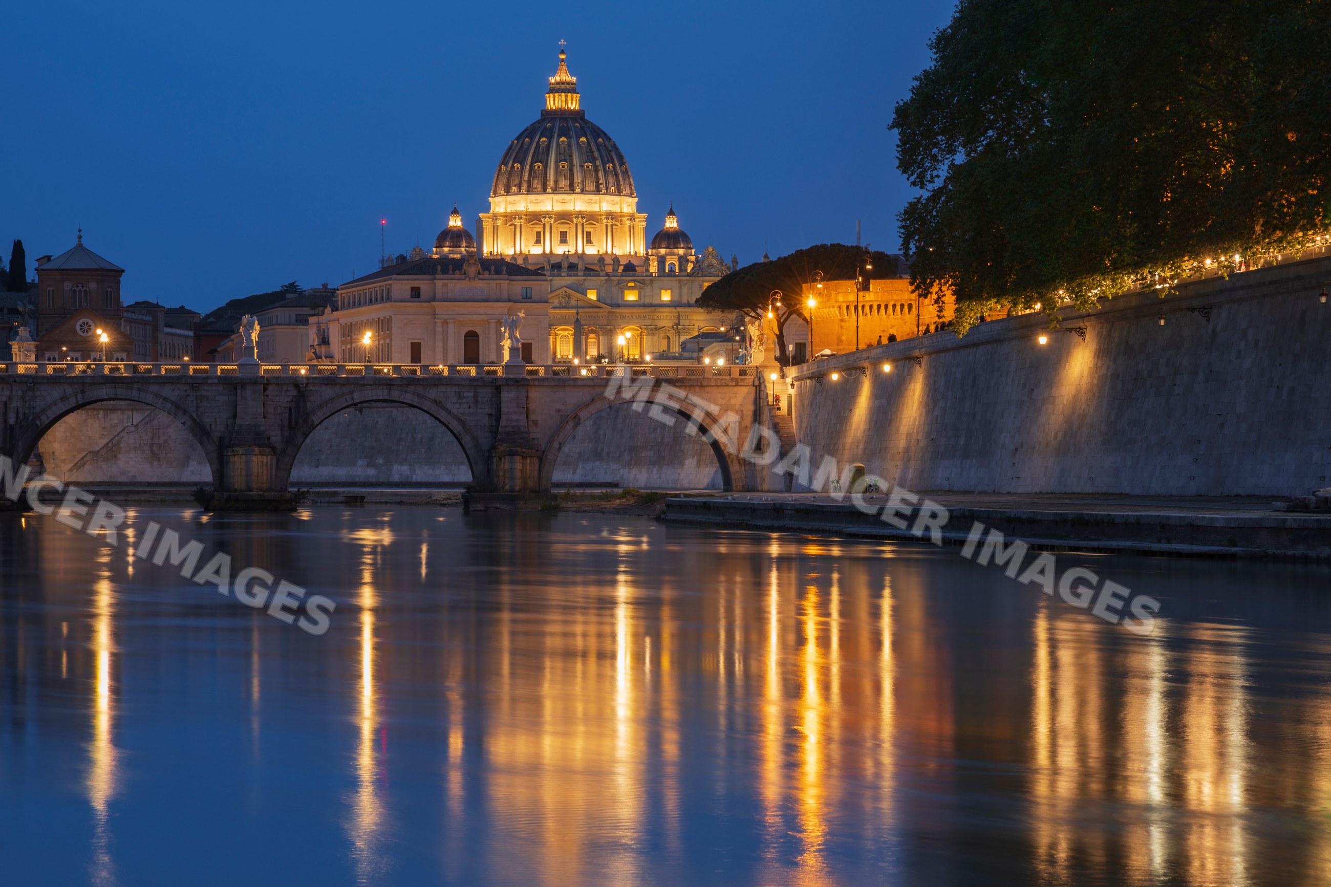 View of st peter's basilica and Tiber River at dusk in rome