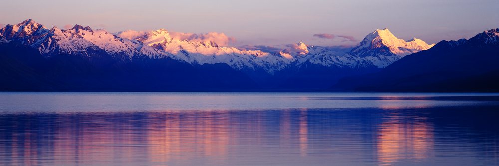 Mountains reflecting on lake during sunset