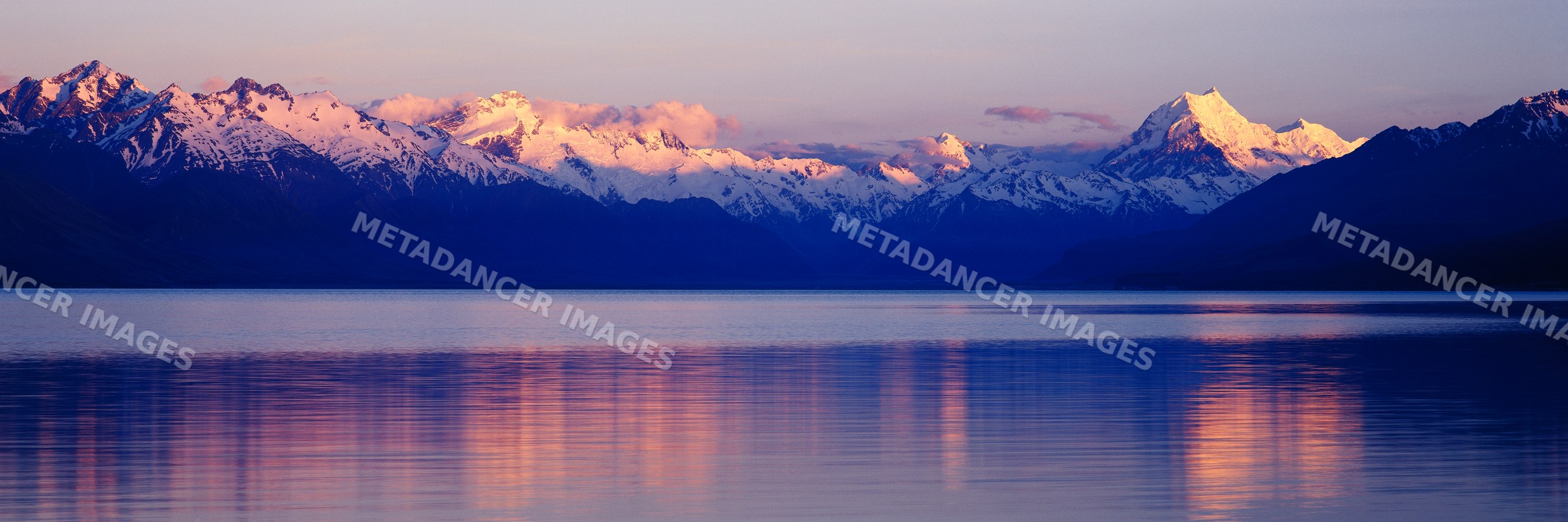 Mountains reflecting on lake during sunset