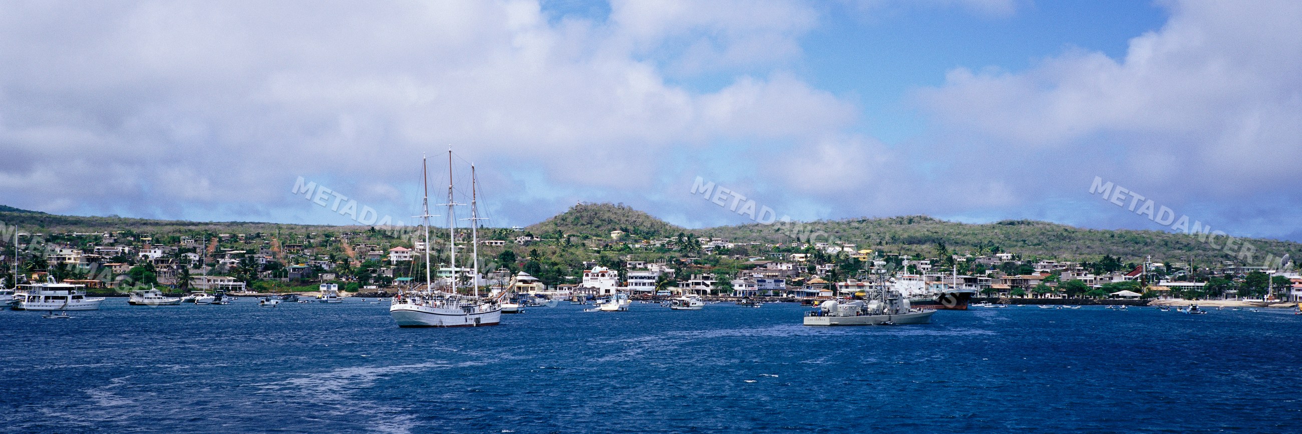Puerto baquerizo morena harbor with boats and coastal town panorama