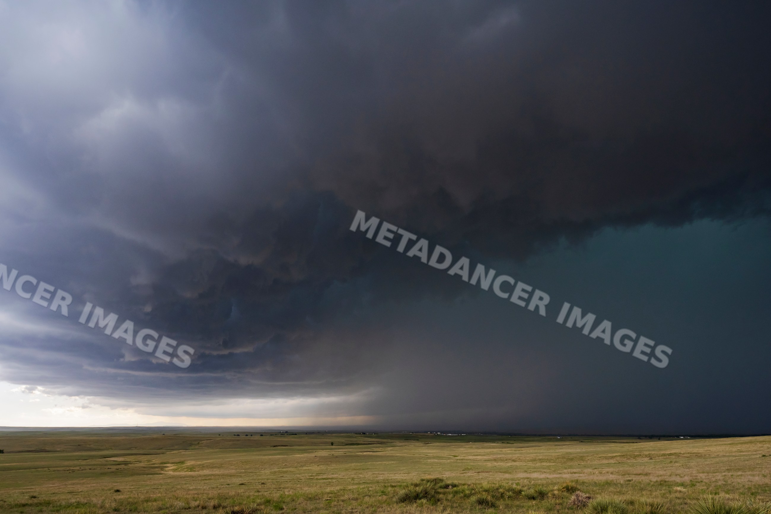 Storm clouds gathering over grassy plains in agate, colorado