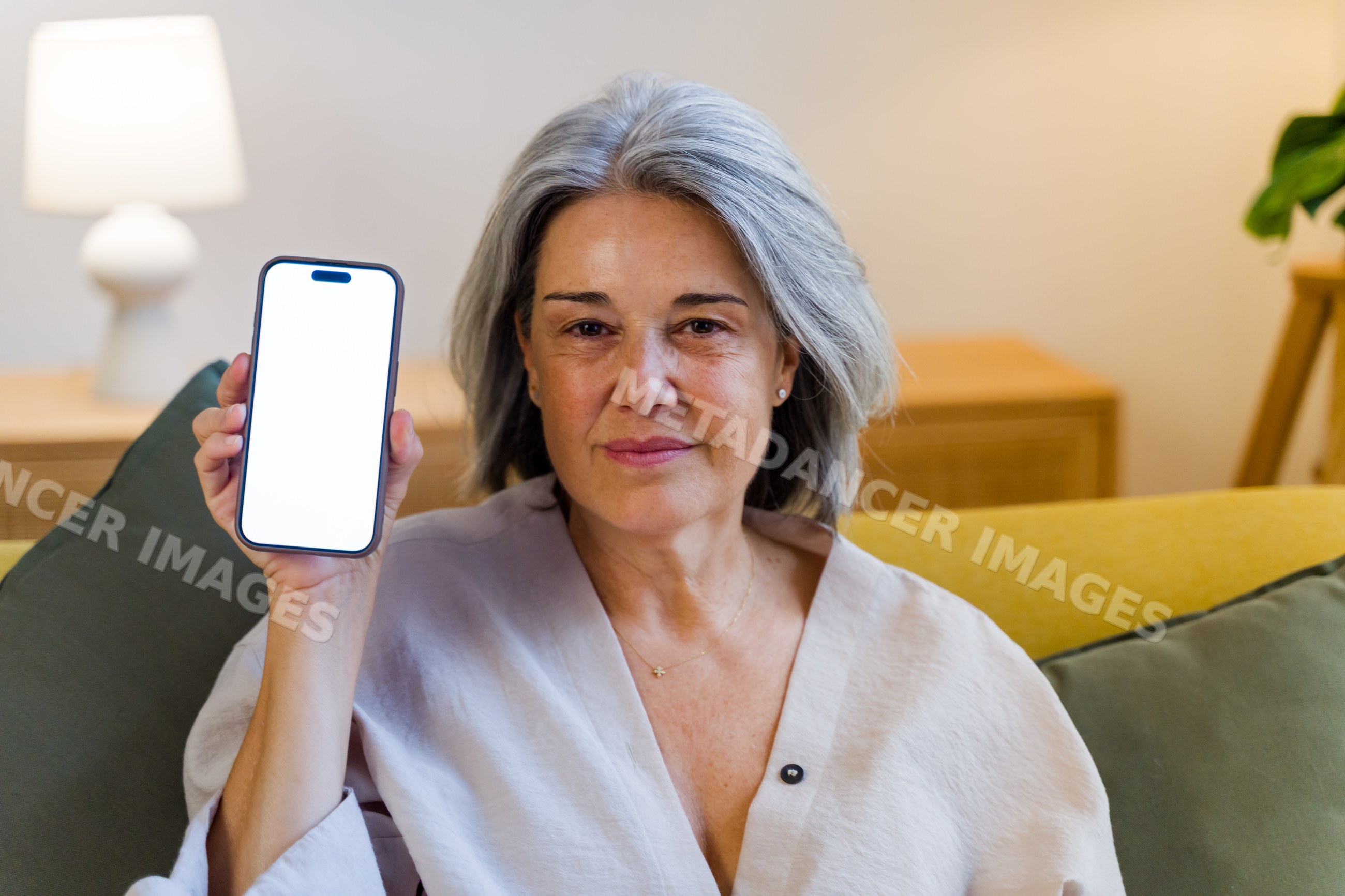 White woman holding smartphone with blank screen