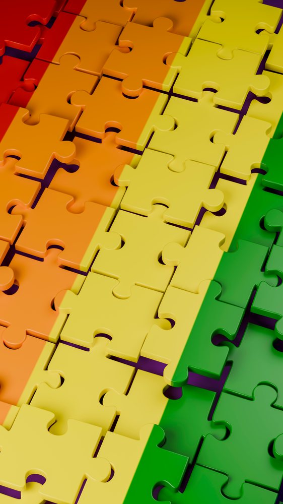 Colorful interlocking jigsaw puzzle pieces forming a vibrant pattern