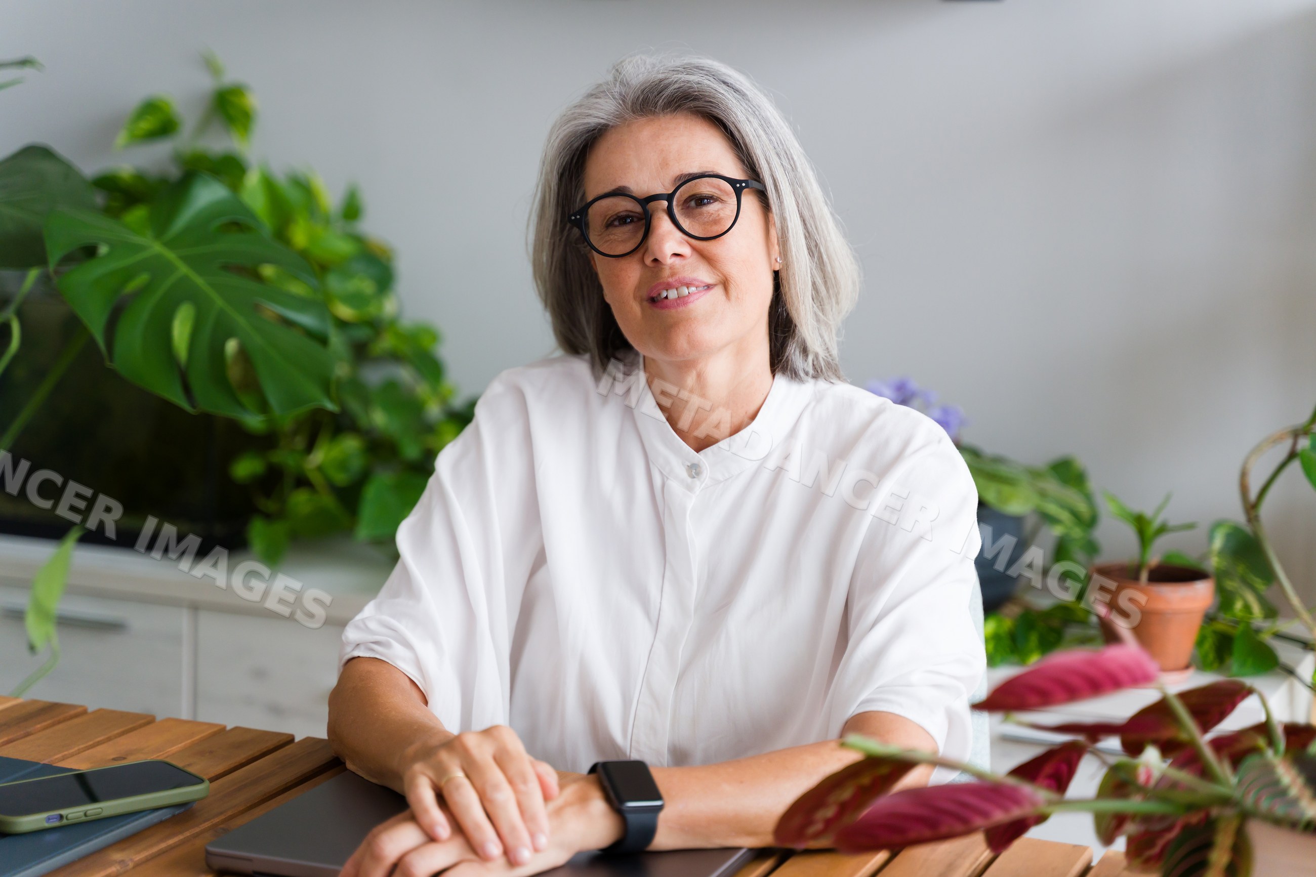 Mature white woman sitting indoors
