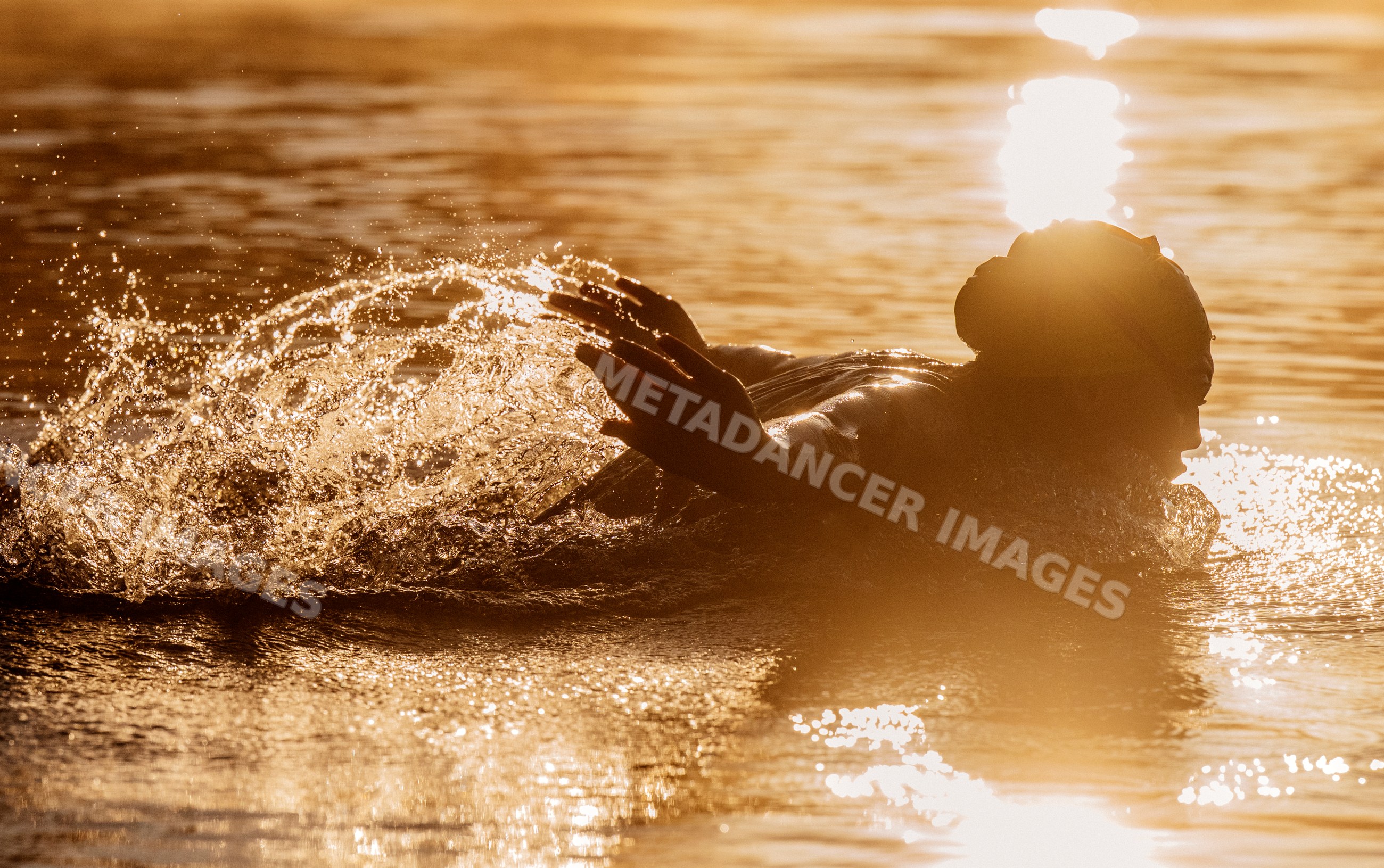 White person performing a swimming stroke with splashing water