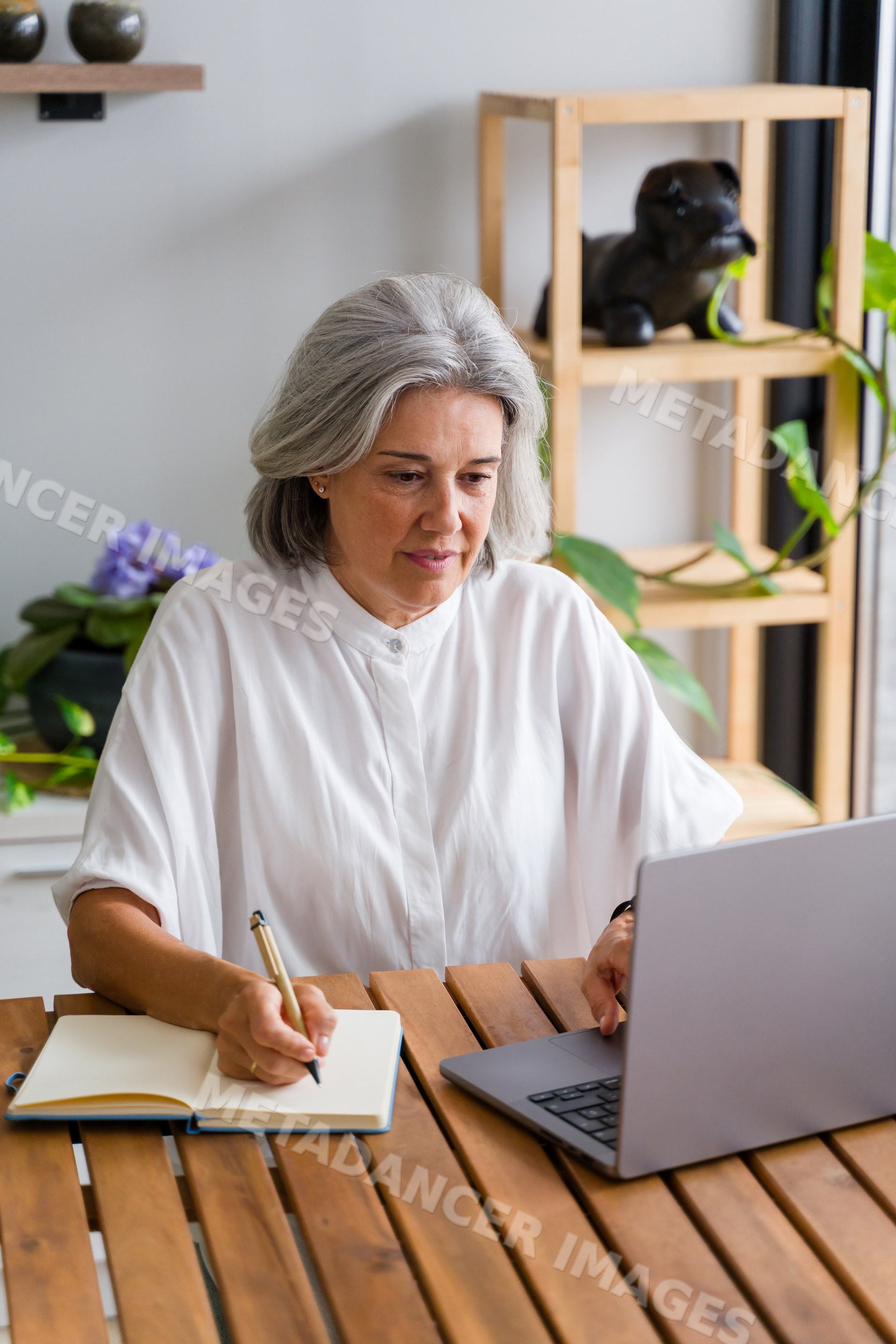White Woman writing in notebook