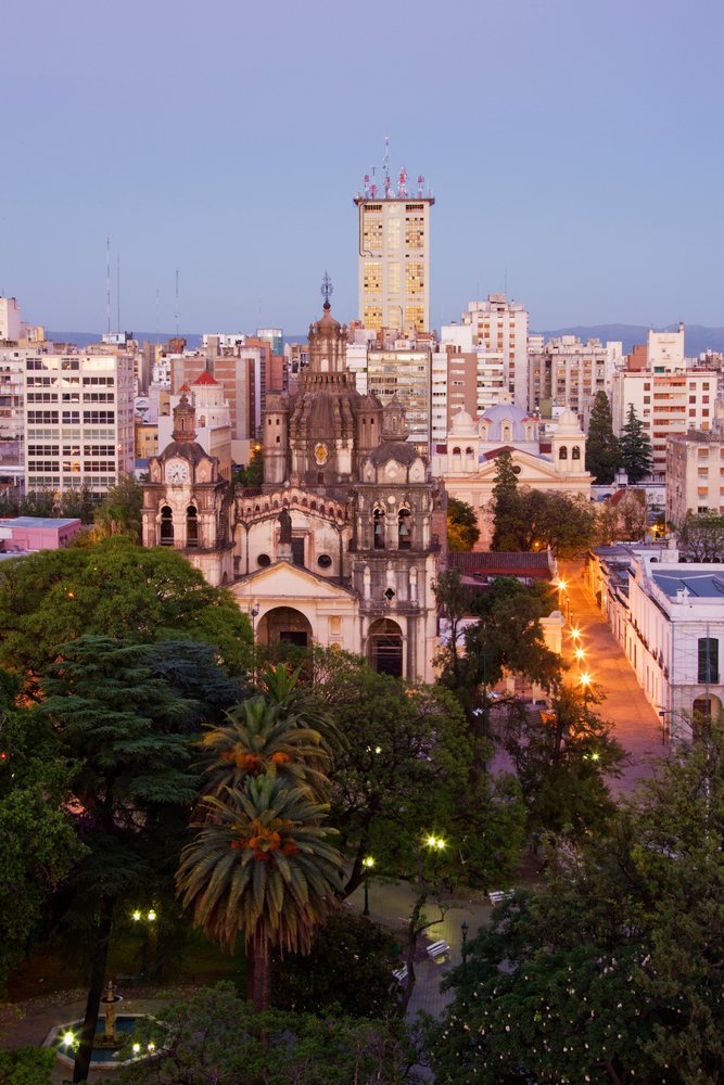 Cordoba cathedral surrounded by cityscape and park at dusk