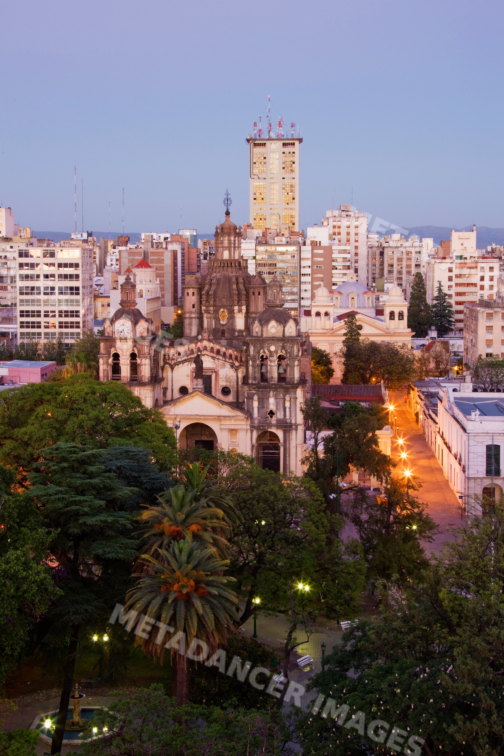Cordoba cathedral surrounded by cityscape and park at dusk