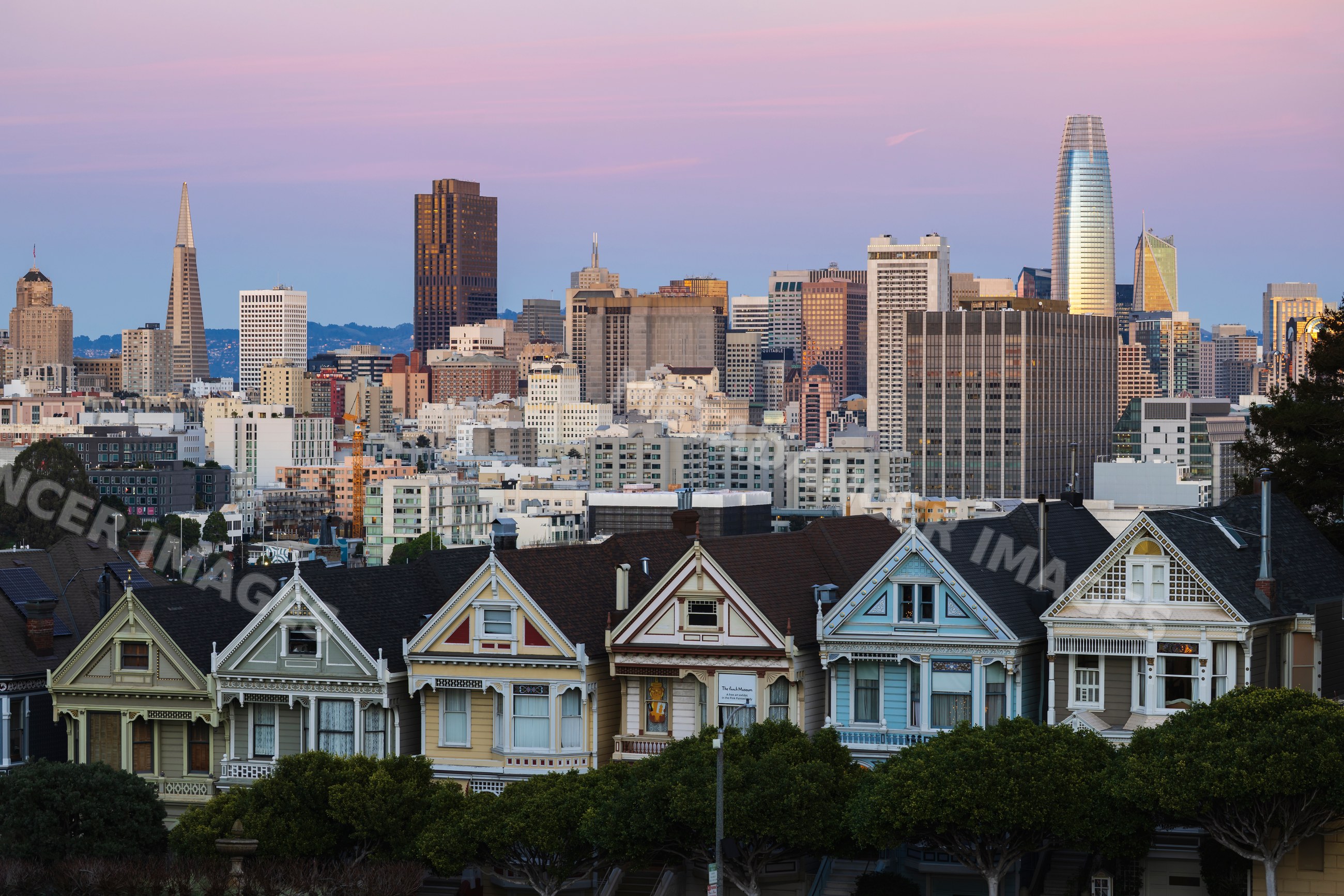 San Francisco Skyline with victorian painted ladies houses at twilight
