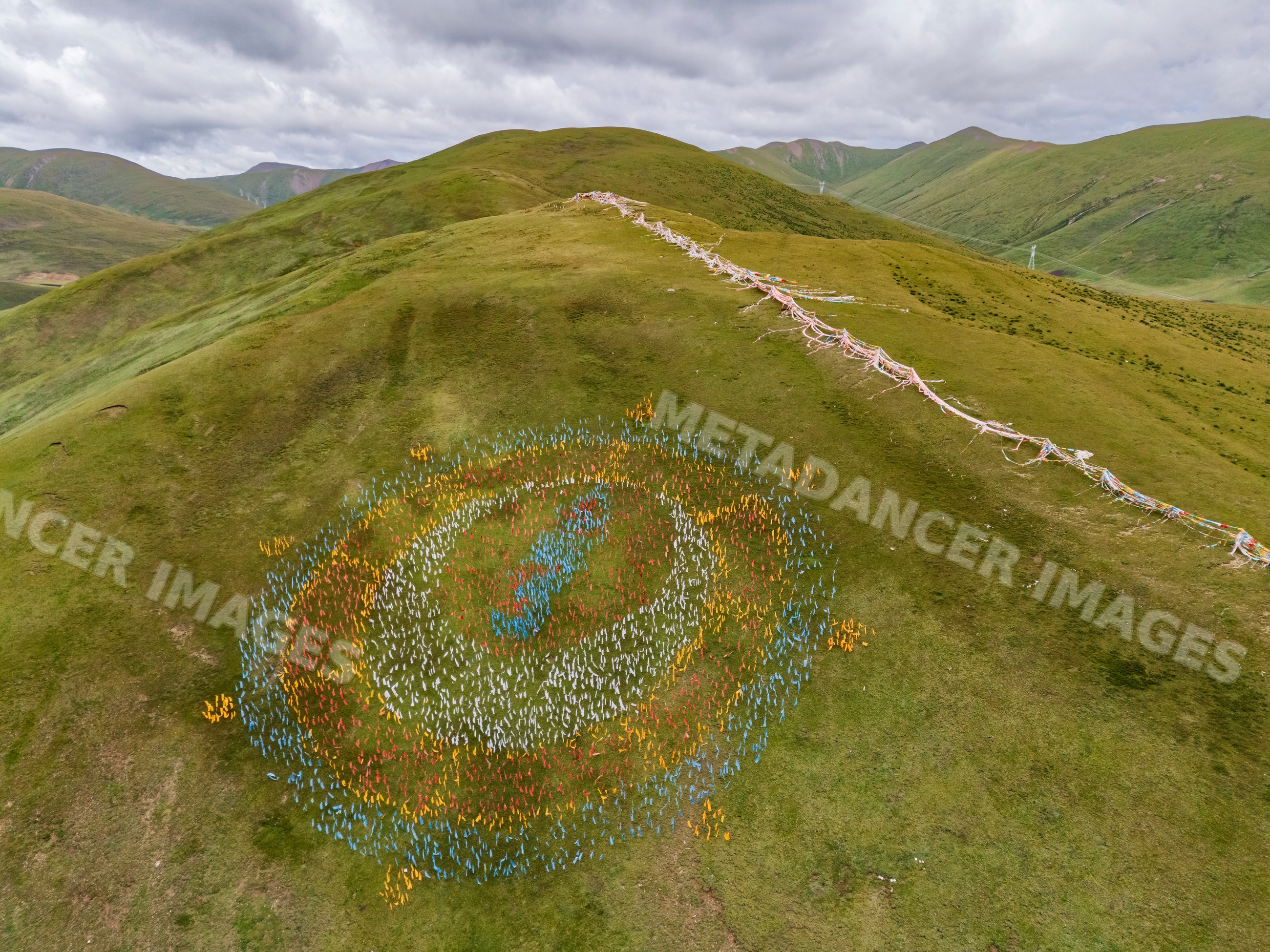 Aerial view of a prayer flag symbol on a hill