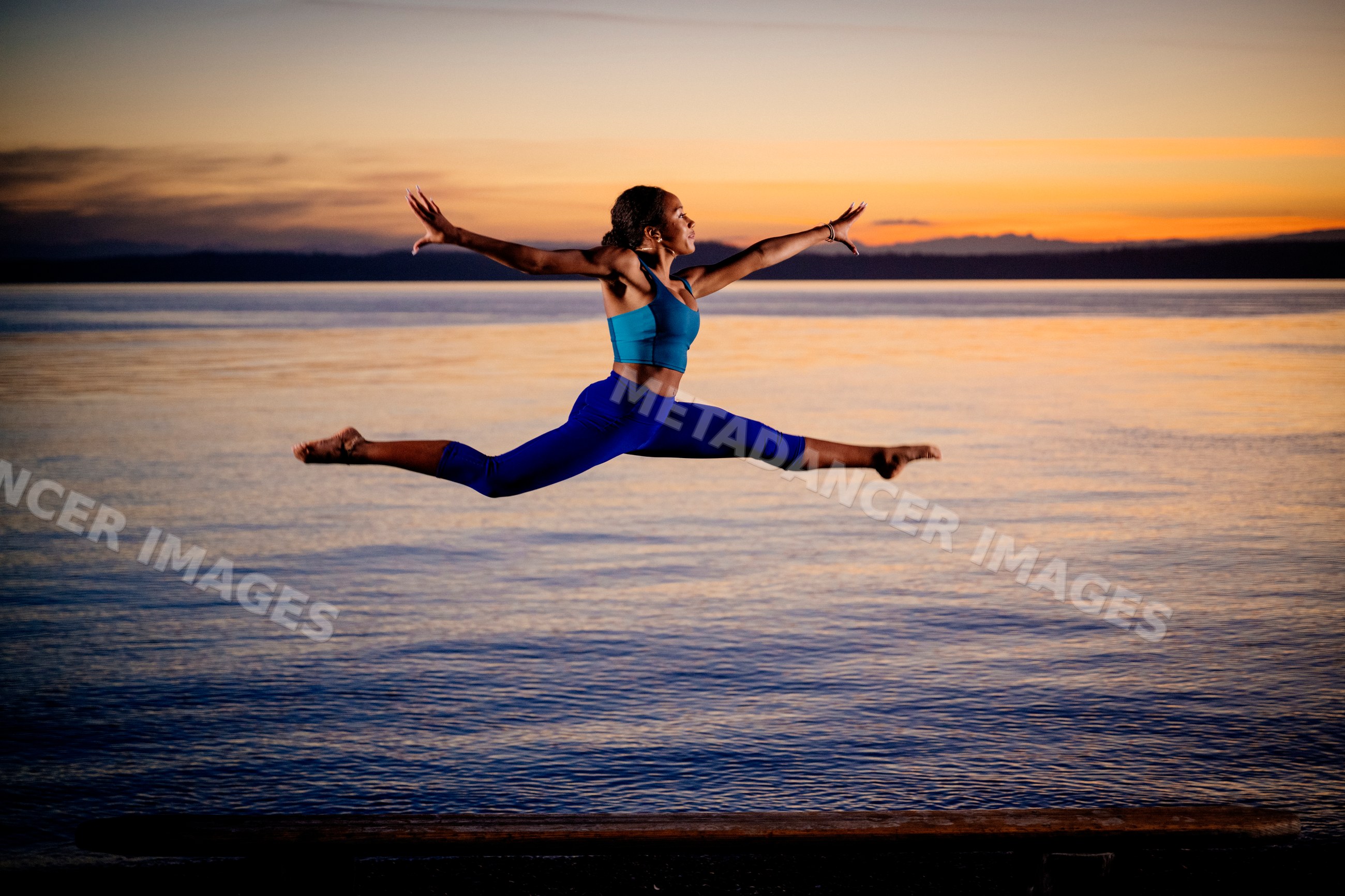 Hispanic woman performing a jumping split leap outdoor