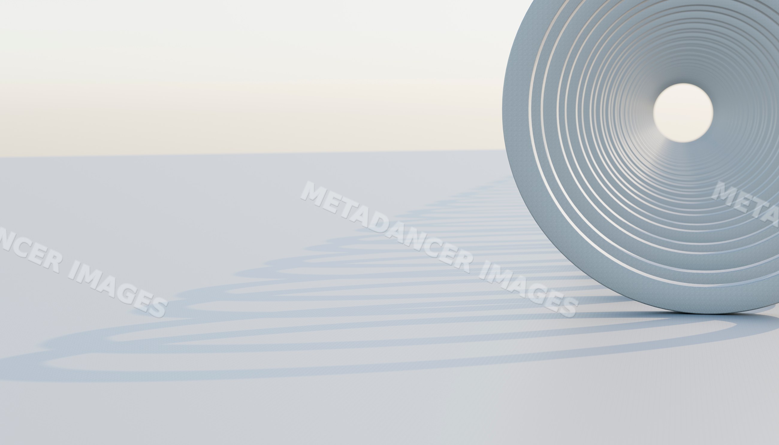 Close-up of a steel coil compression spring casting a spiral shadow