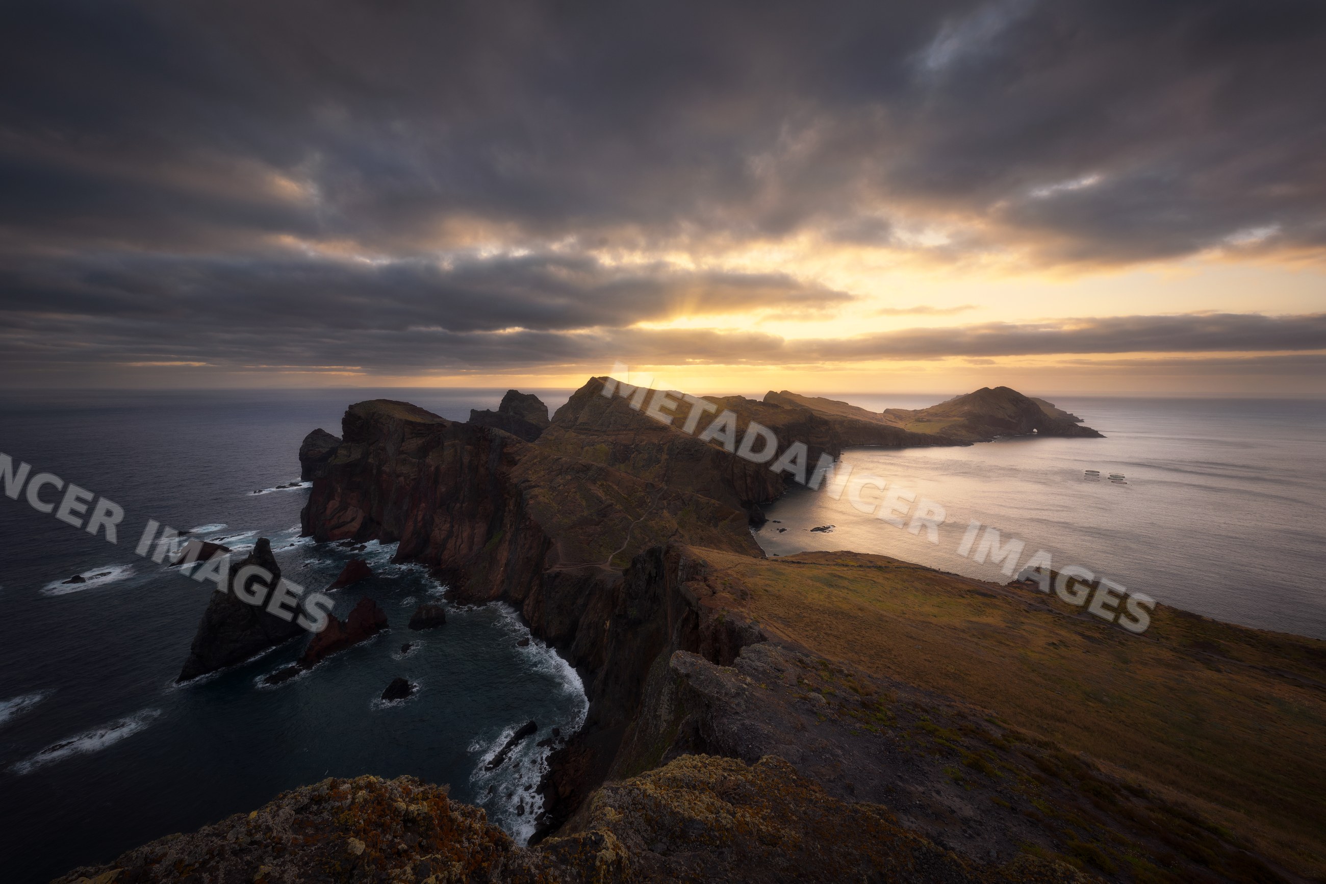 Sunset illuminates rocky coastline and ocean cliffs on Madeira Island