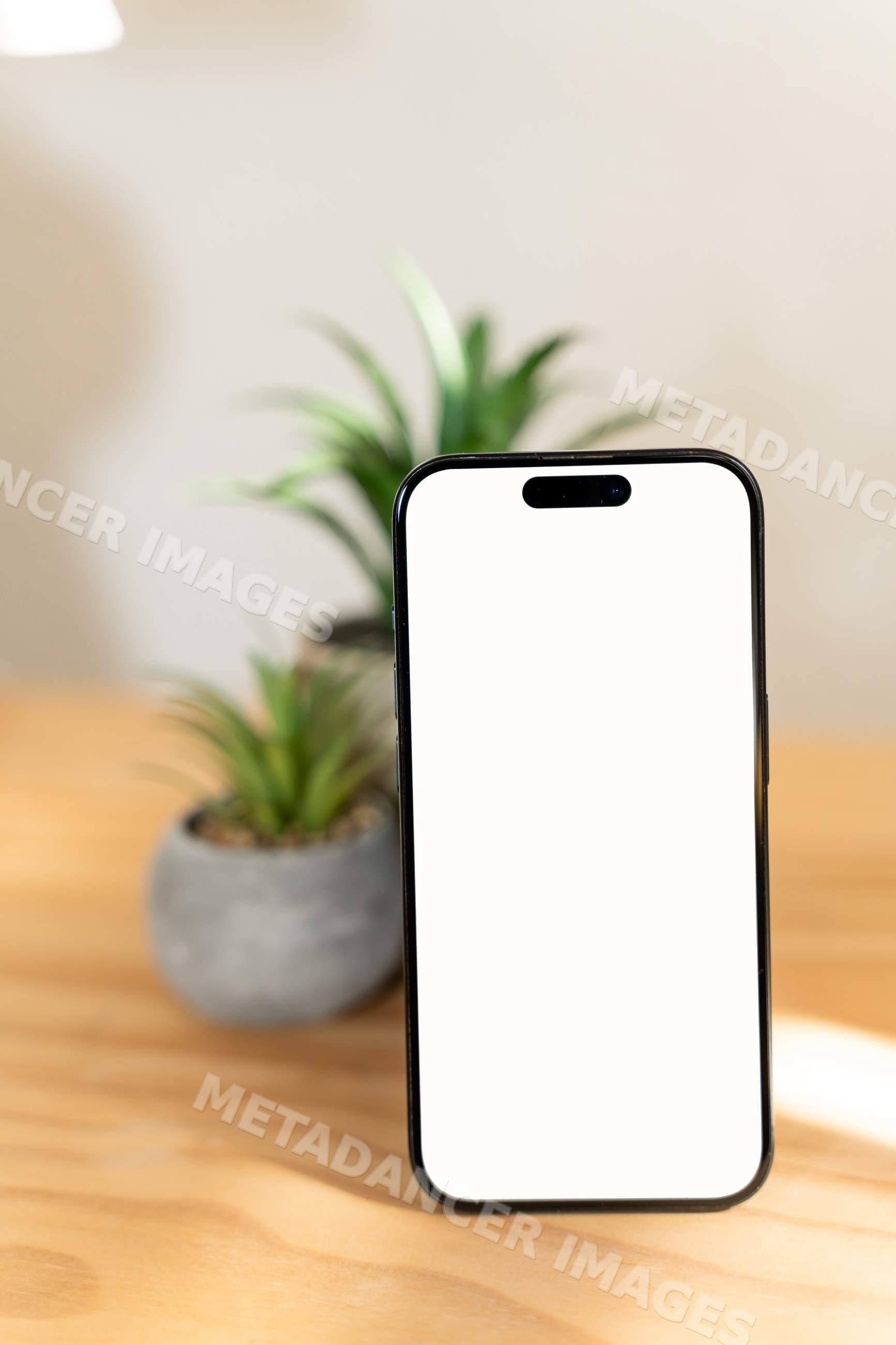 Smartphone with blank screen on wooden table