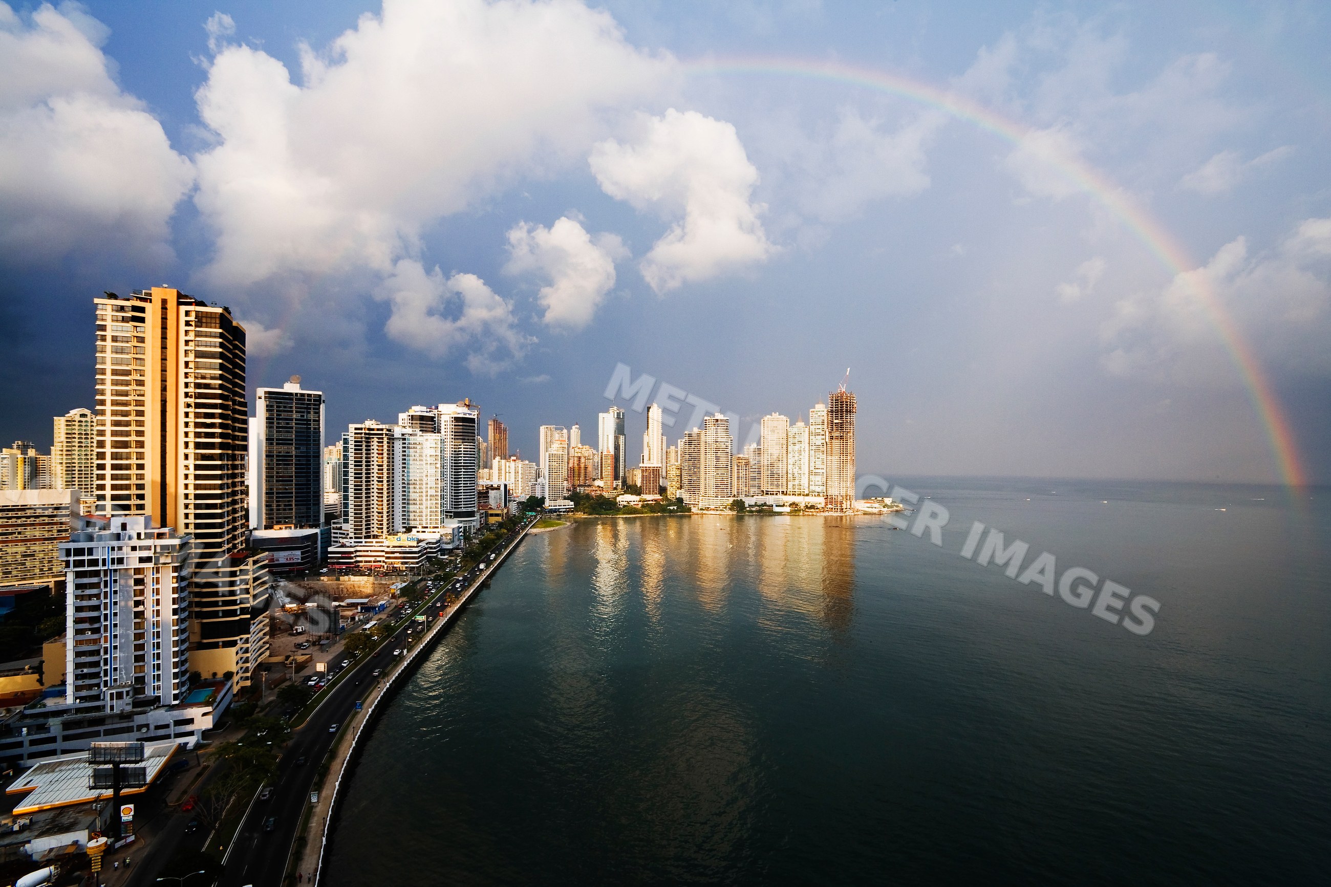 Panama city skyline with rainbow over ocean waterfront