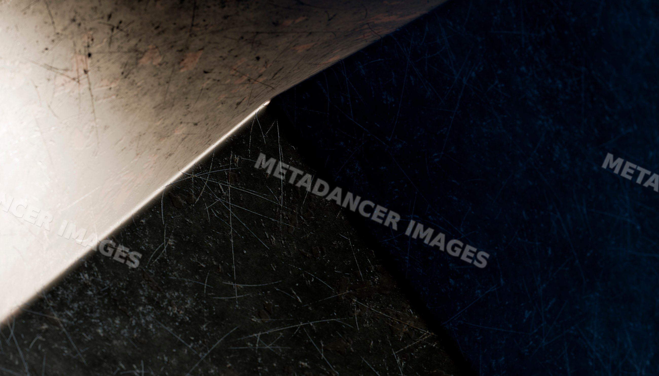 Close-up view of a scratched metal sheet corner with detailed texture
