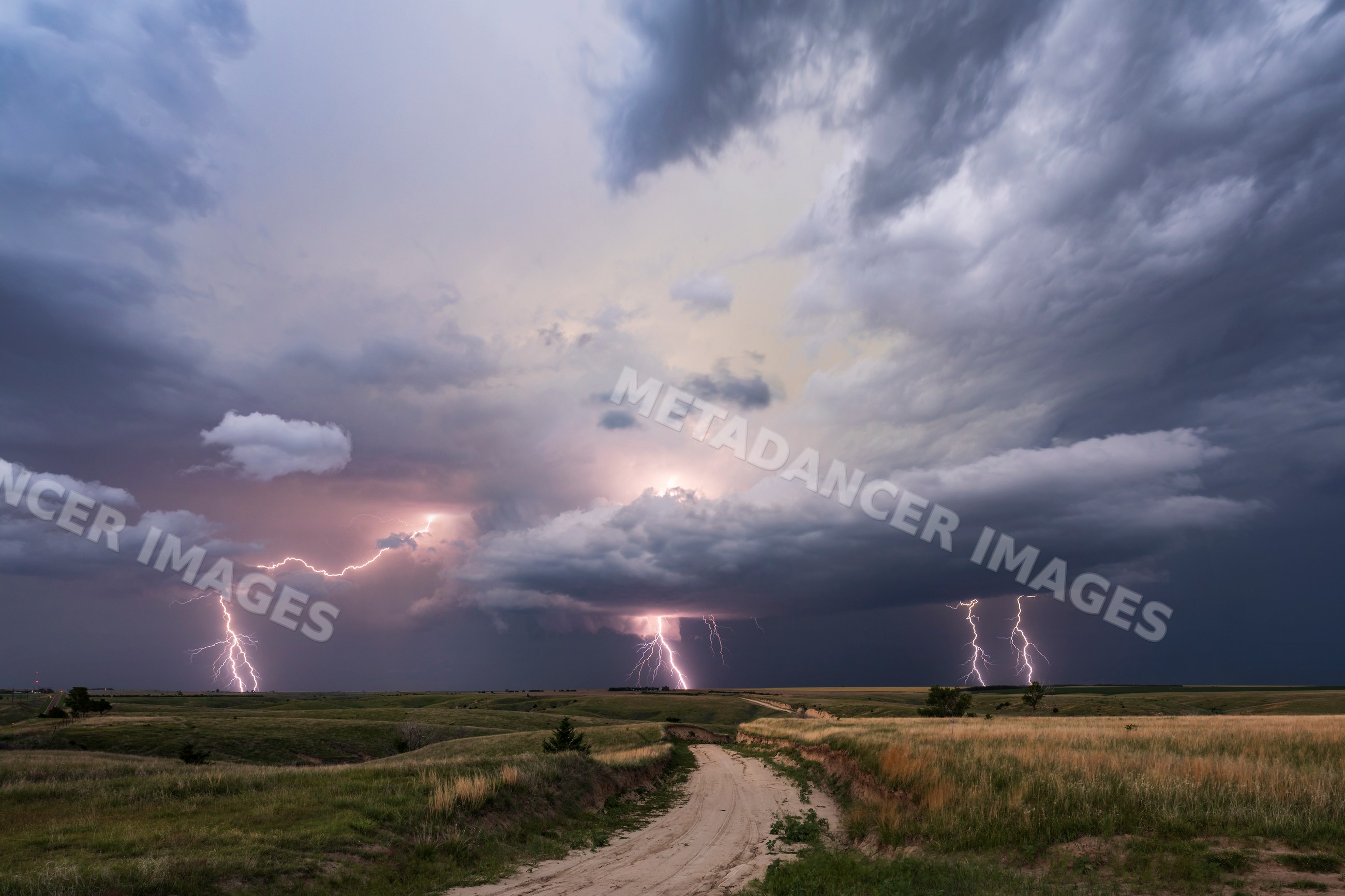Lightning strikes from Supercell storm over rural nebraska grasslands