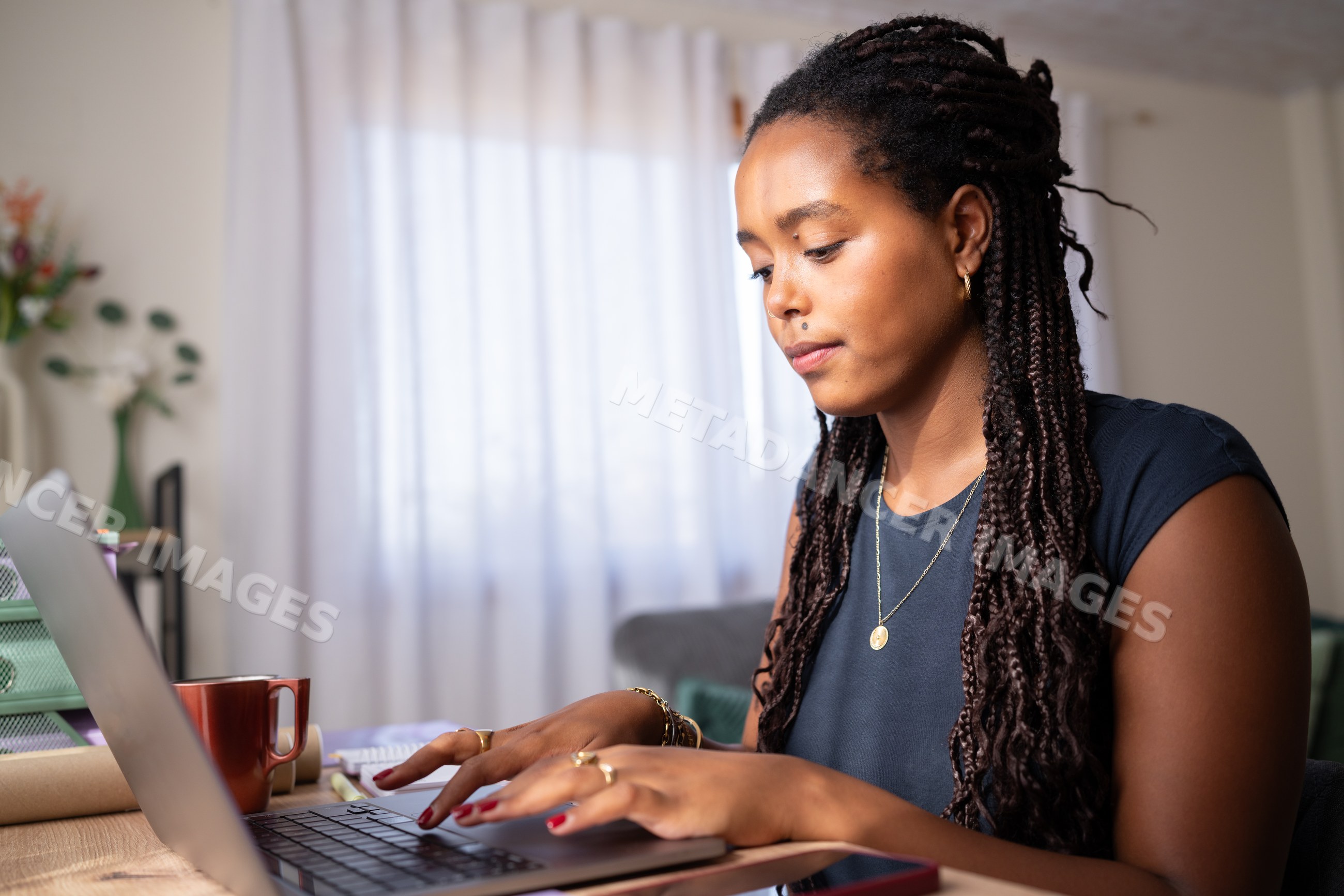 African American woman typing on a laptop