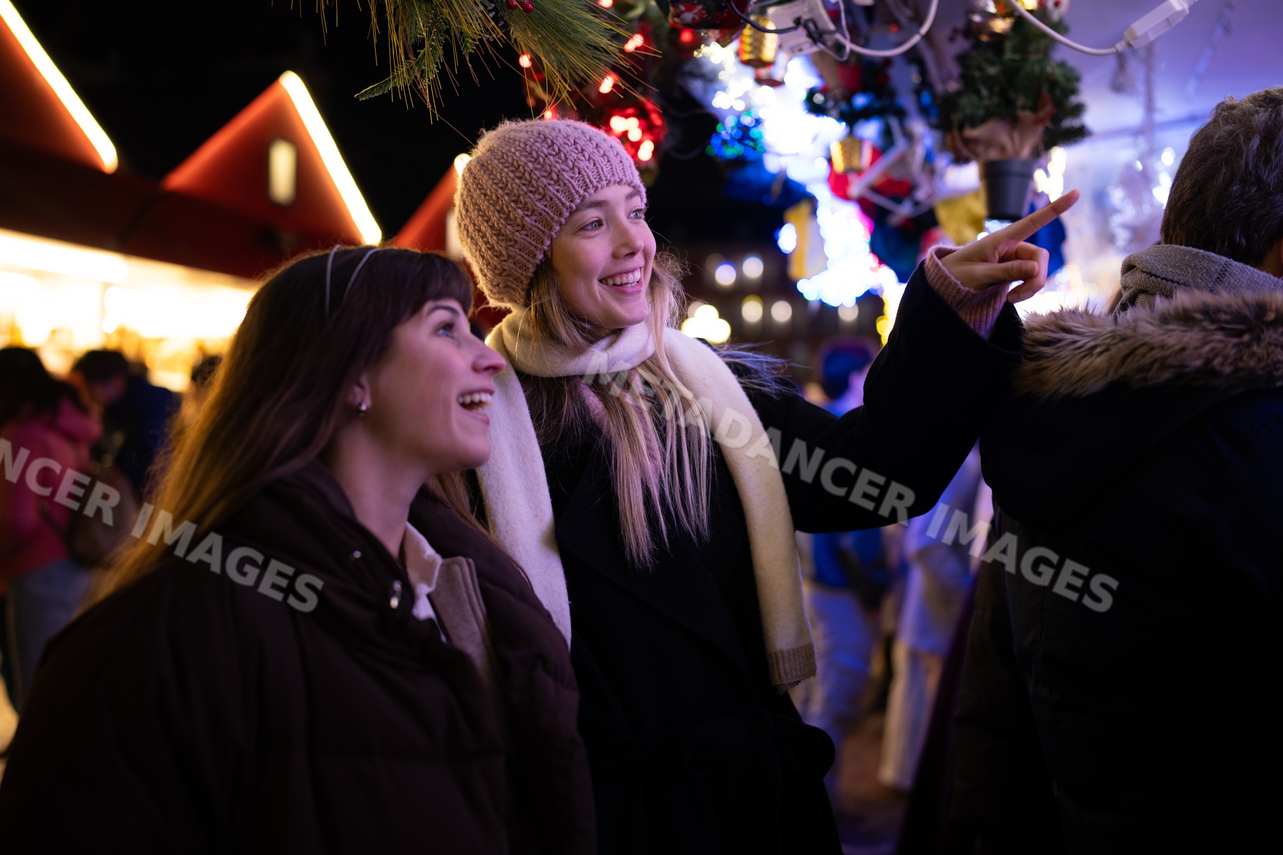 White women enjoying festive lights