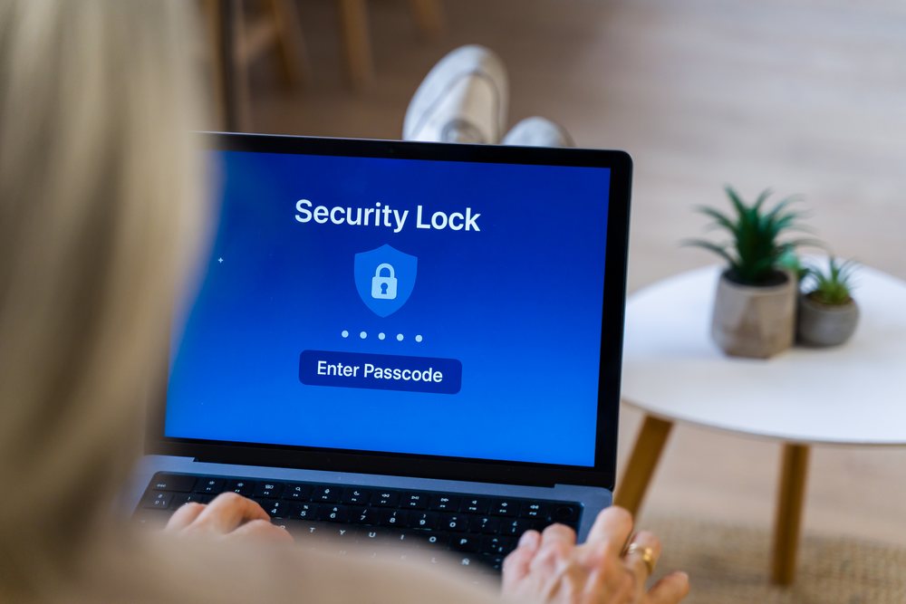 Laptop displaying security lock screen with passcode entry