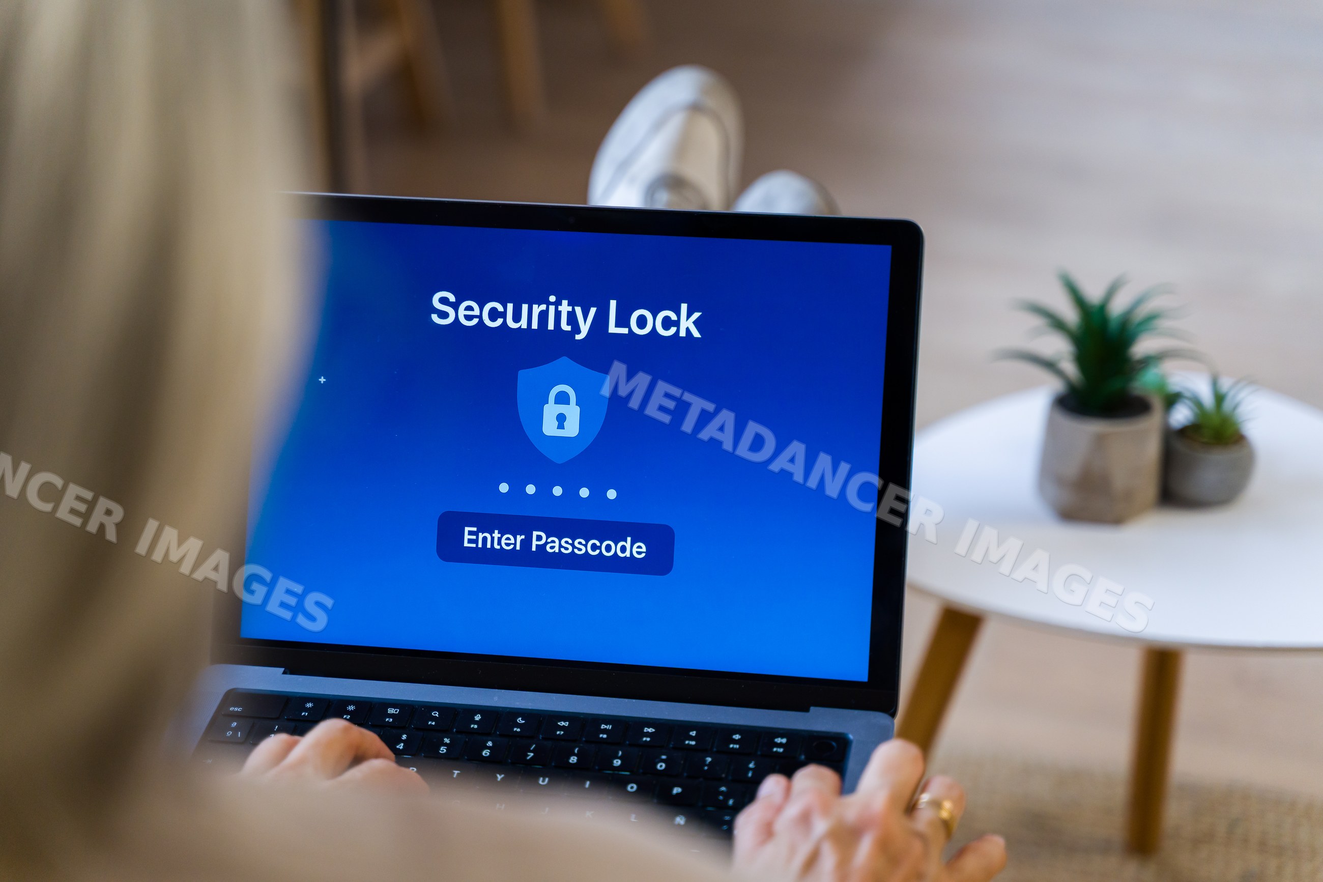 Laptop displaying security lock screen with passcode entry