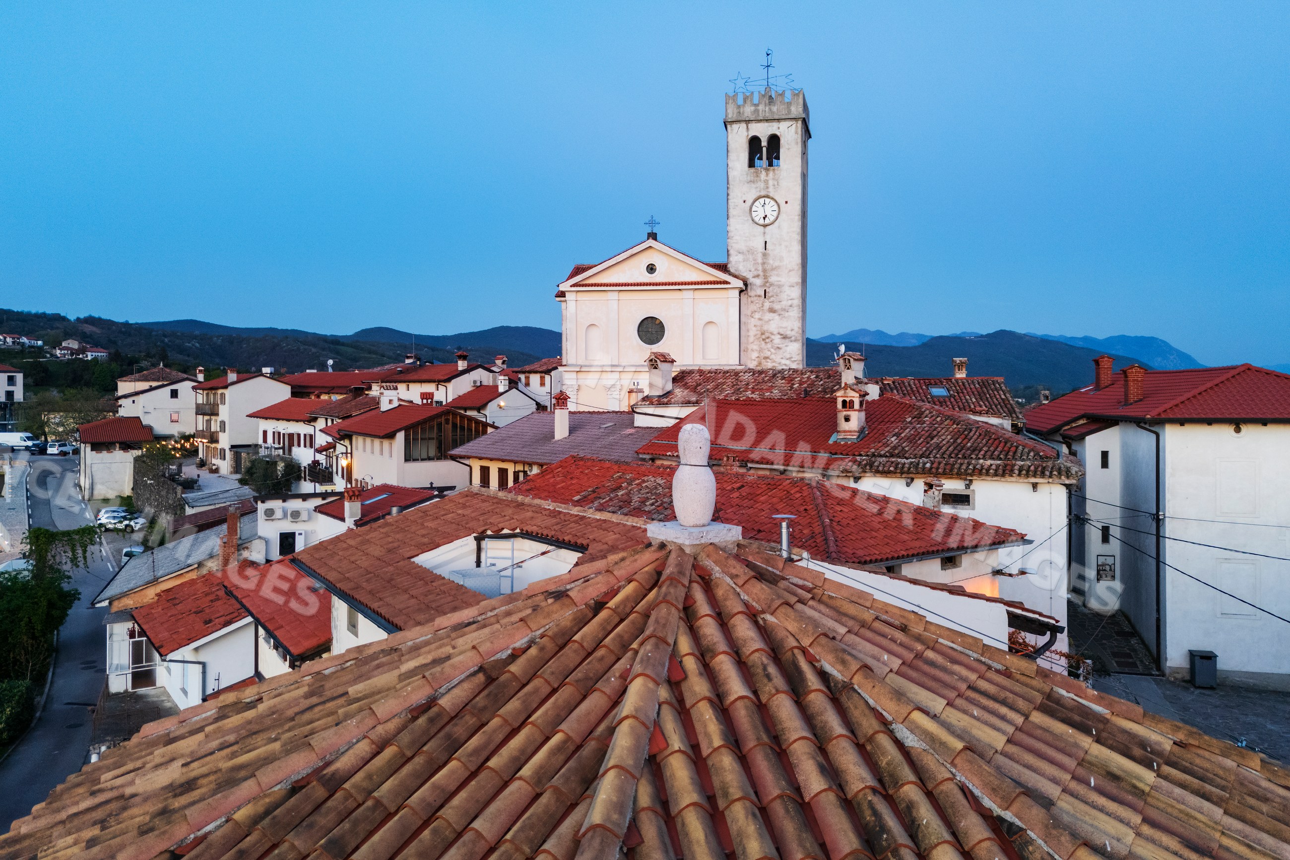 Church of st martin with clock tower at dusk in vipava valley