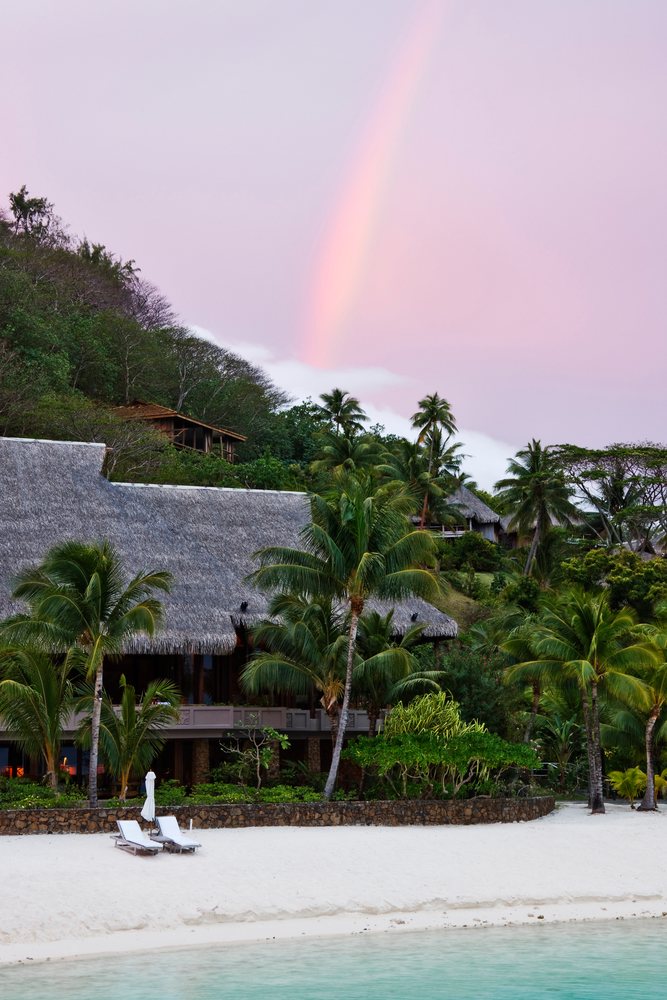 Rainbow over tropical resort beach french polynesia