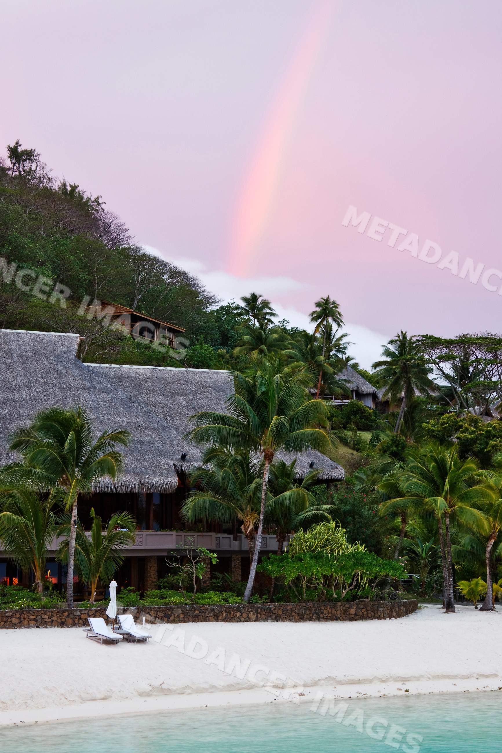 Rainbow over tropical resort beach french polynesia