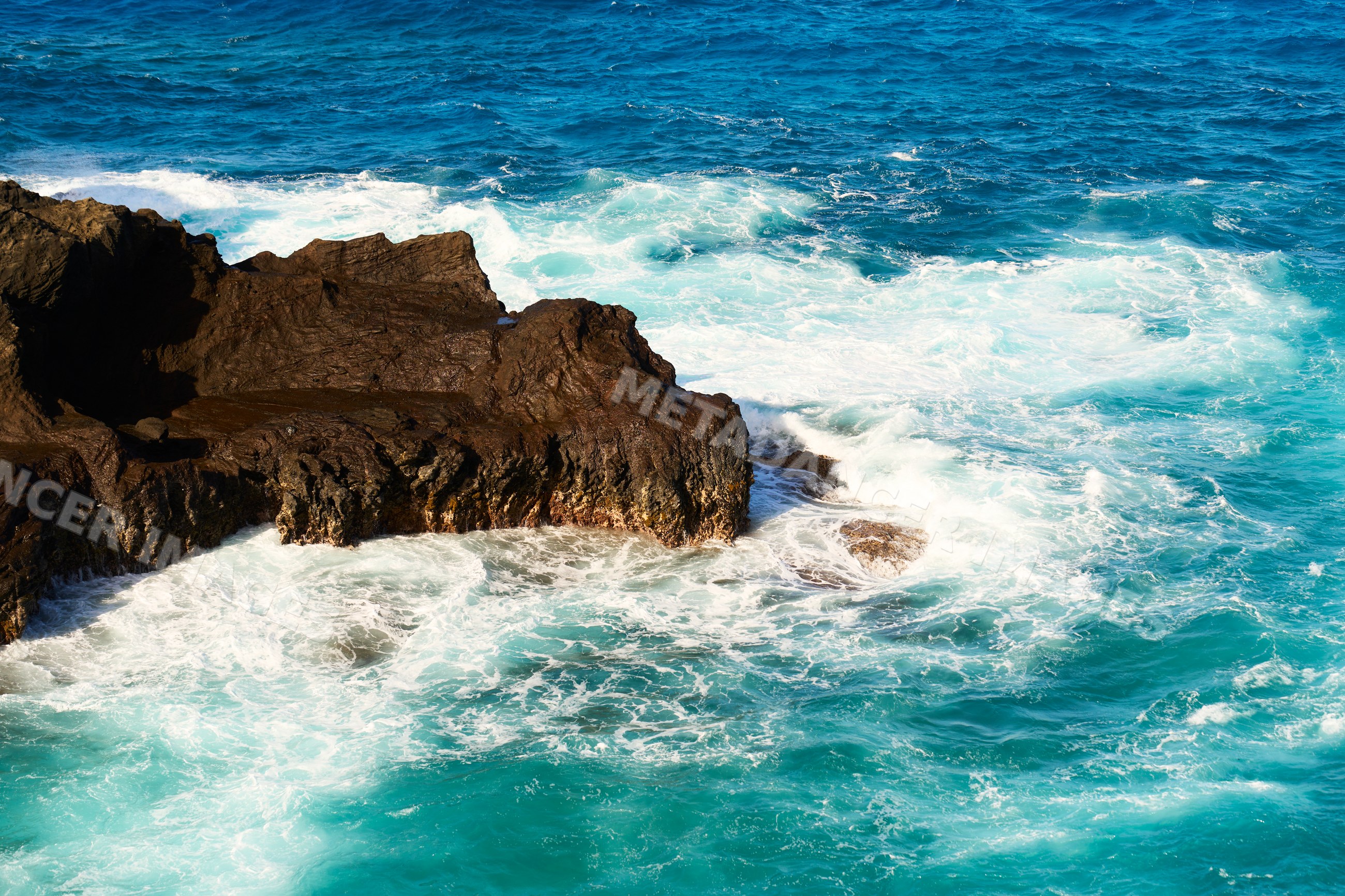 Ocean waves crashing on rocky coastline at Oahu, Hawaii