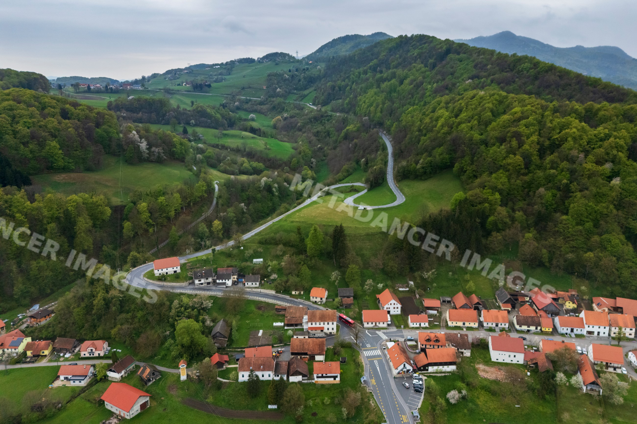 Winding road passing through village of Podsreda