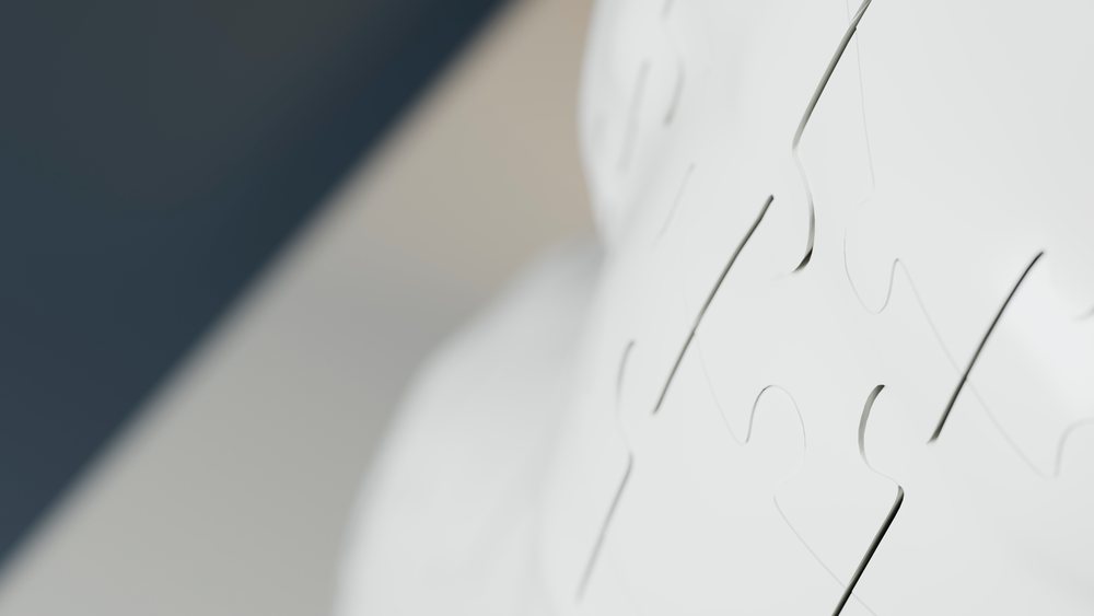 Close-up of assembled white interlocking puzzle pieces