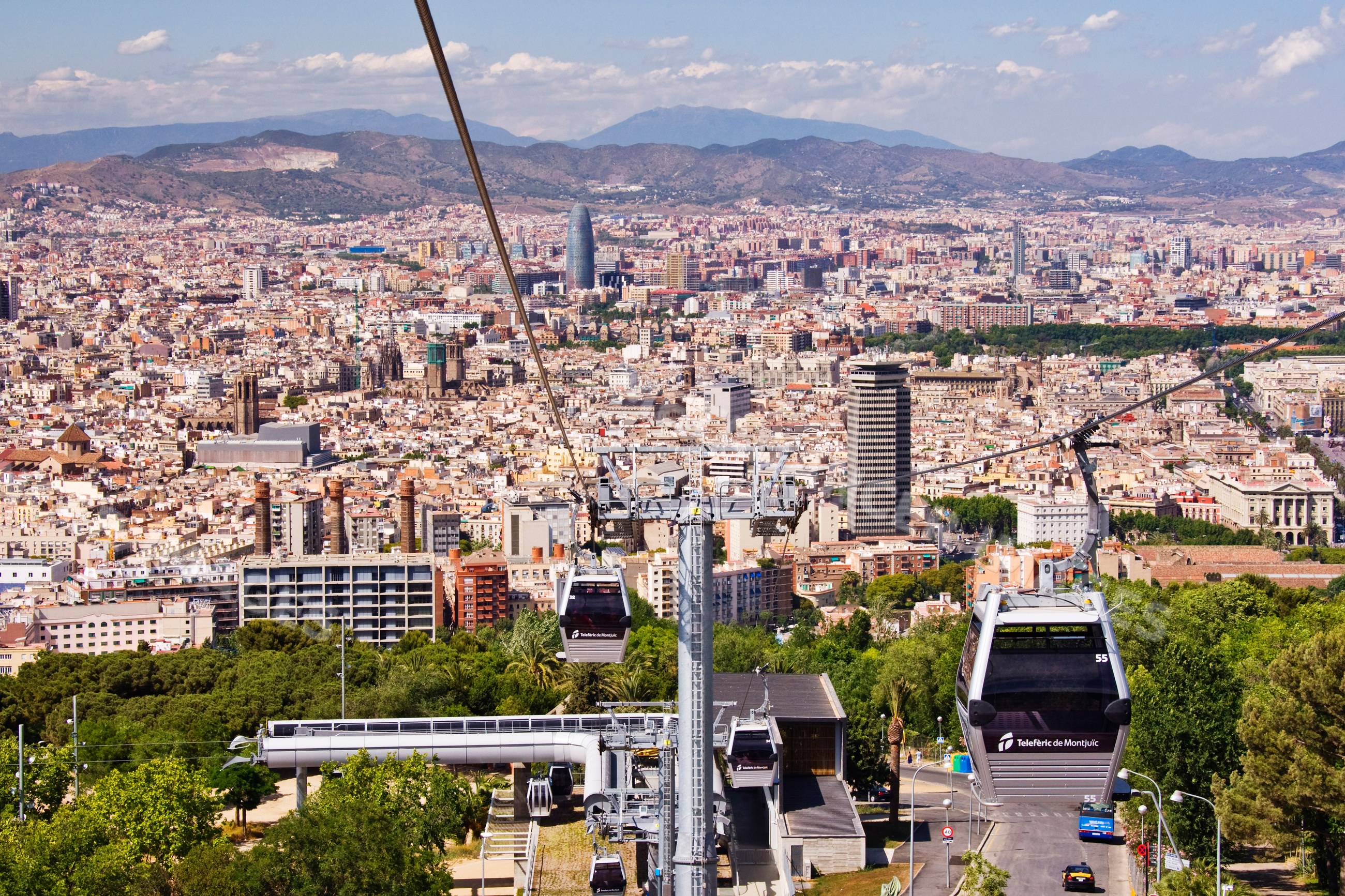 Cable car cabins of telefèric de montjuïc over barcelona cityscape