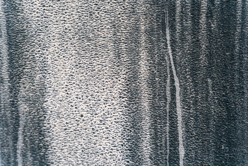 Textured black and white abstract surface with granular pattern